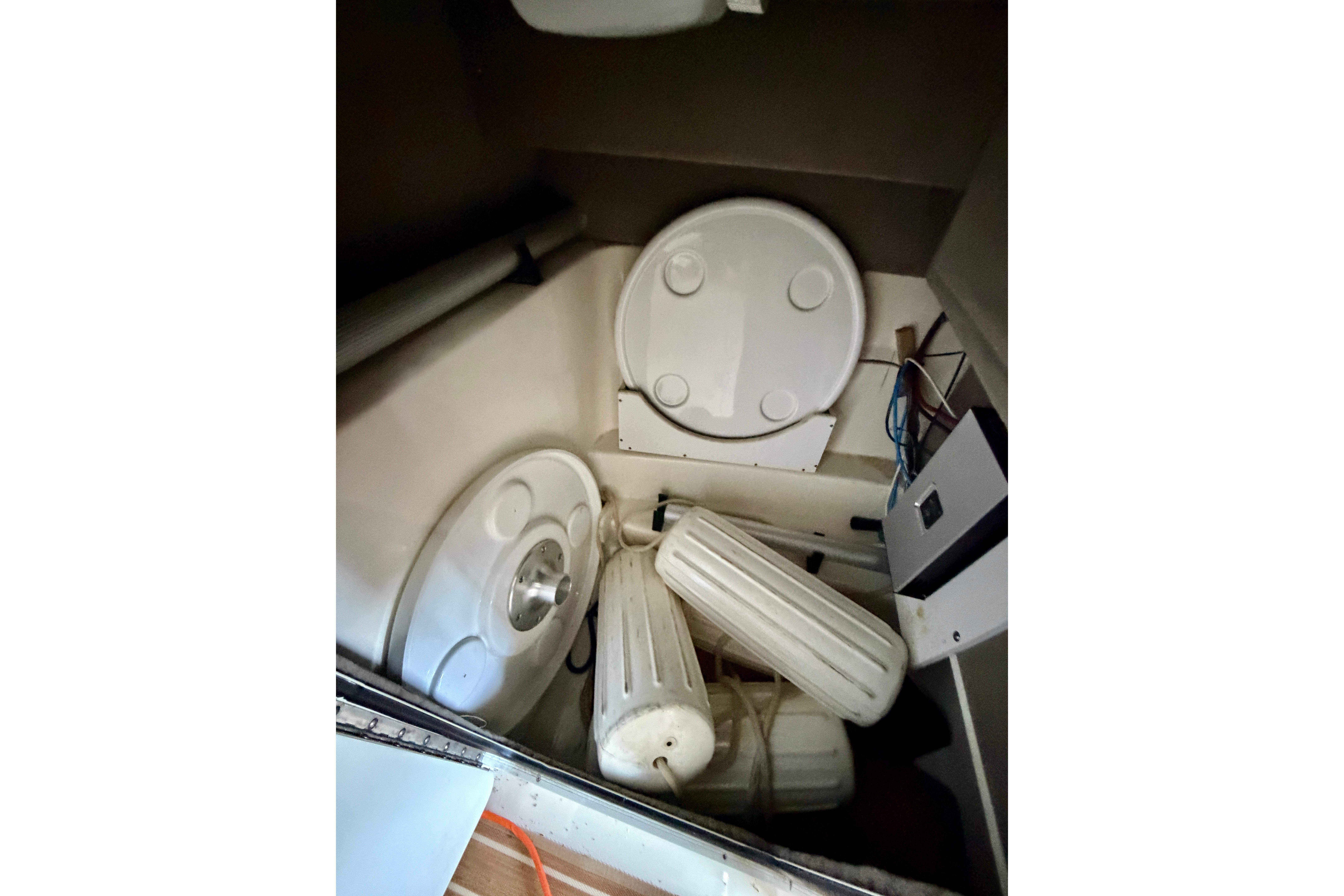 Interior storage area of a 2007 Sea Ray 270 SLX boat with equipment and accessories.