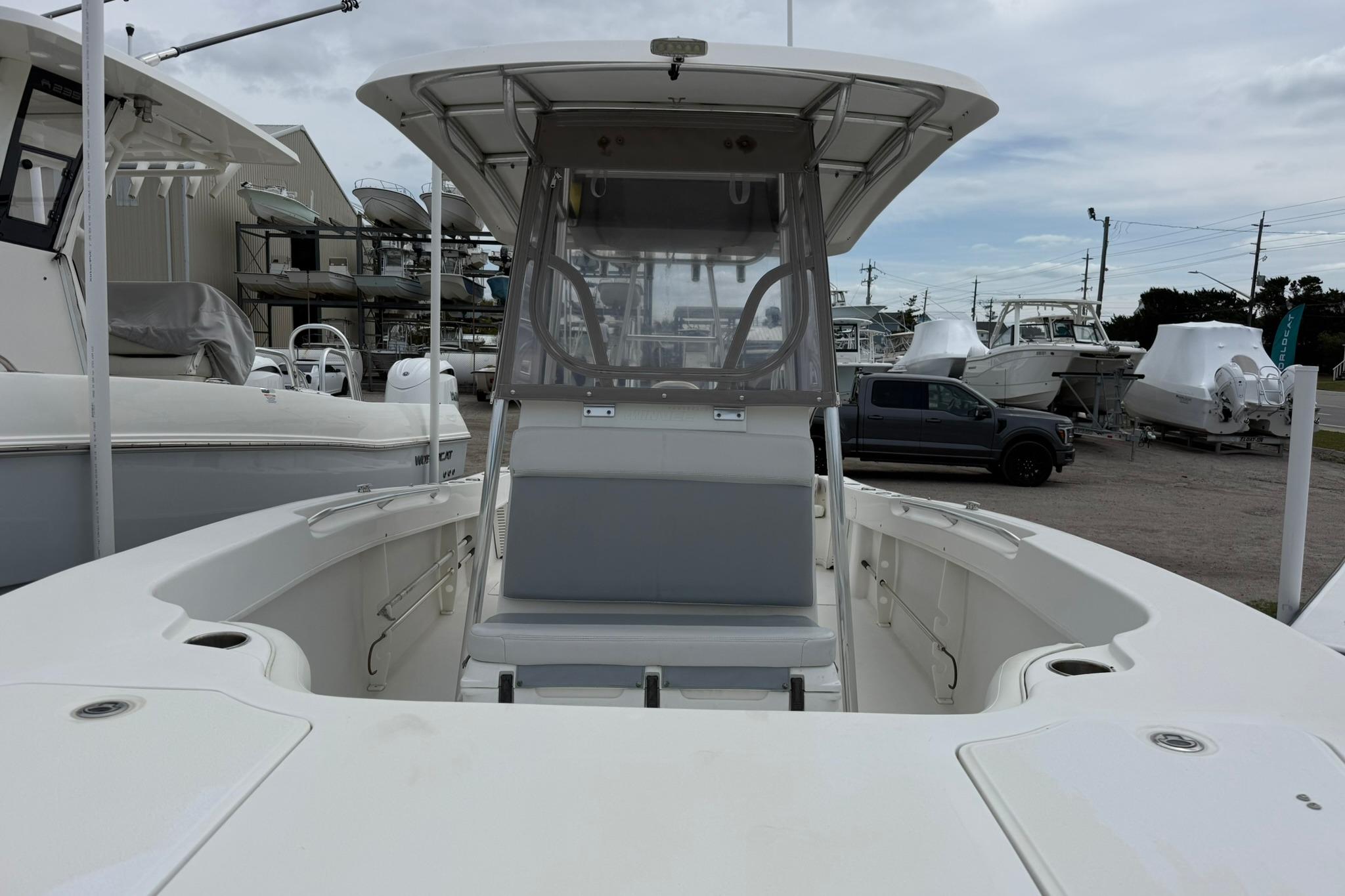 2018 Twin Vee 260 CC SE boat with center console and seating, docked at marina.