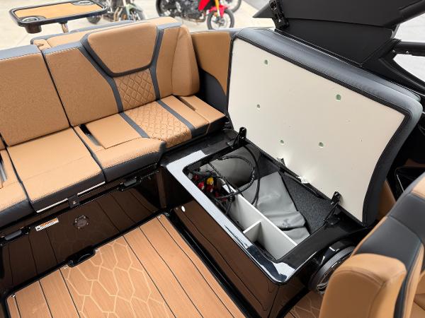 2025 Yamaha Boats 255XD interior with tan seating and open storage compartment.