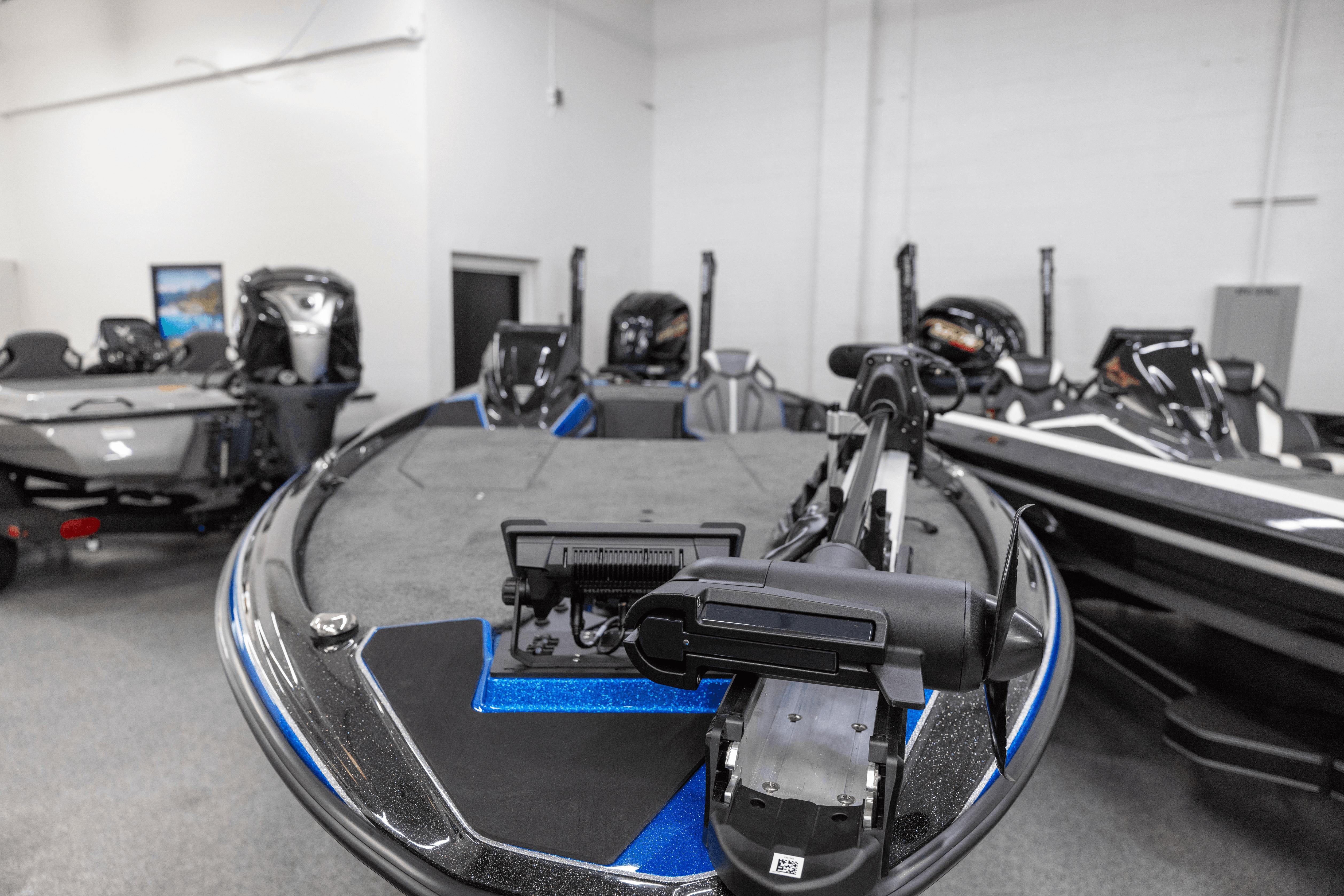 2026 Skeeter ZXE21 bass boat displayed in showroom, featuring advanced fishing technology.
