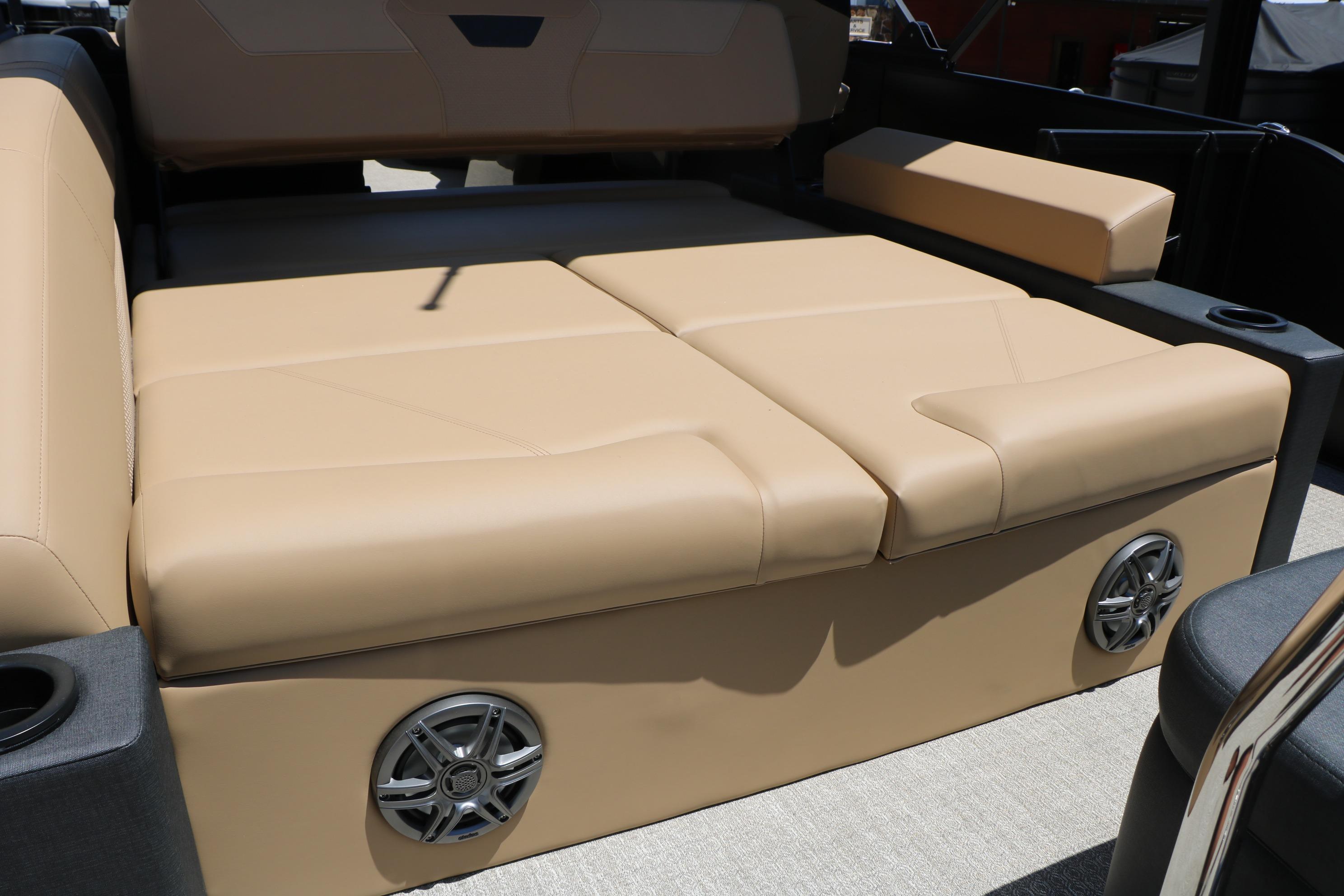 Luxurious beige seating in 2026 Evotti 521CS boat, featuring integrated speakers and cup holders.