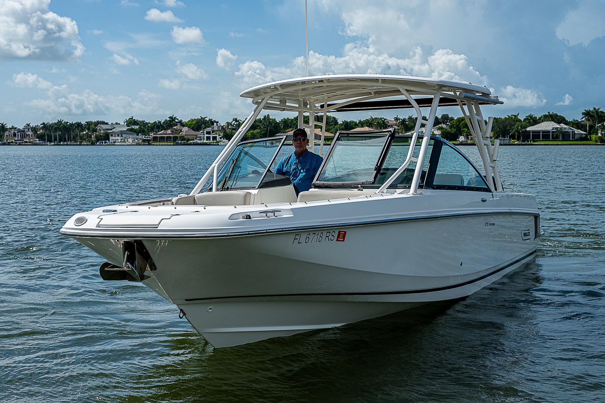 2018 Boston Whaler 270 Vantage boat cruising on a sunny lake.