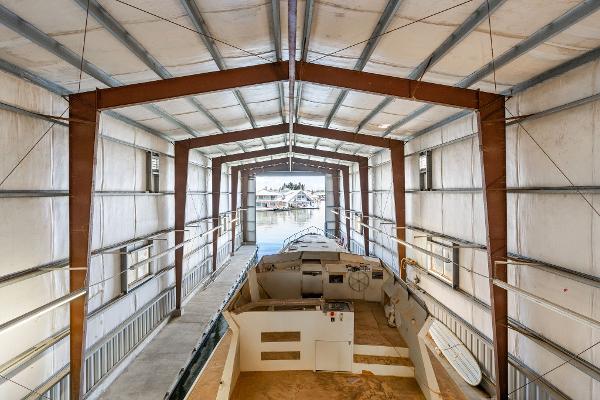 Interior view of a 1985 Custom Larson Boathouse with a boat docked inside.