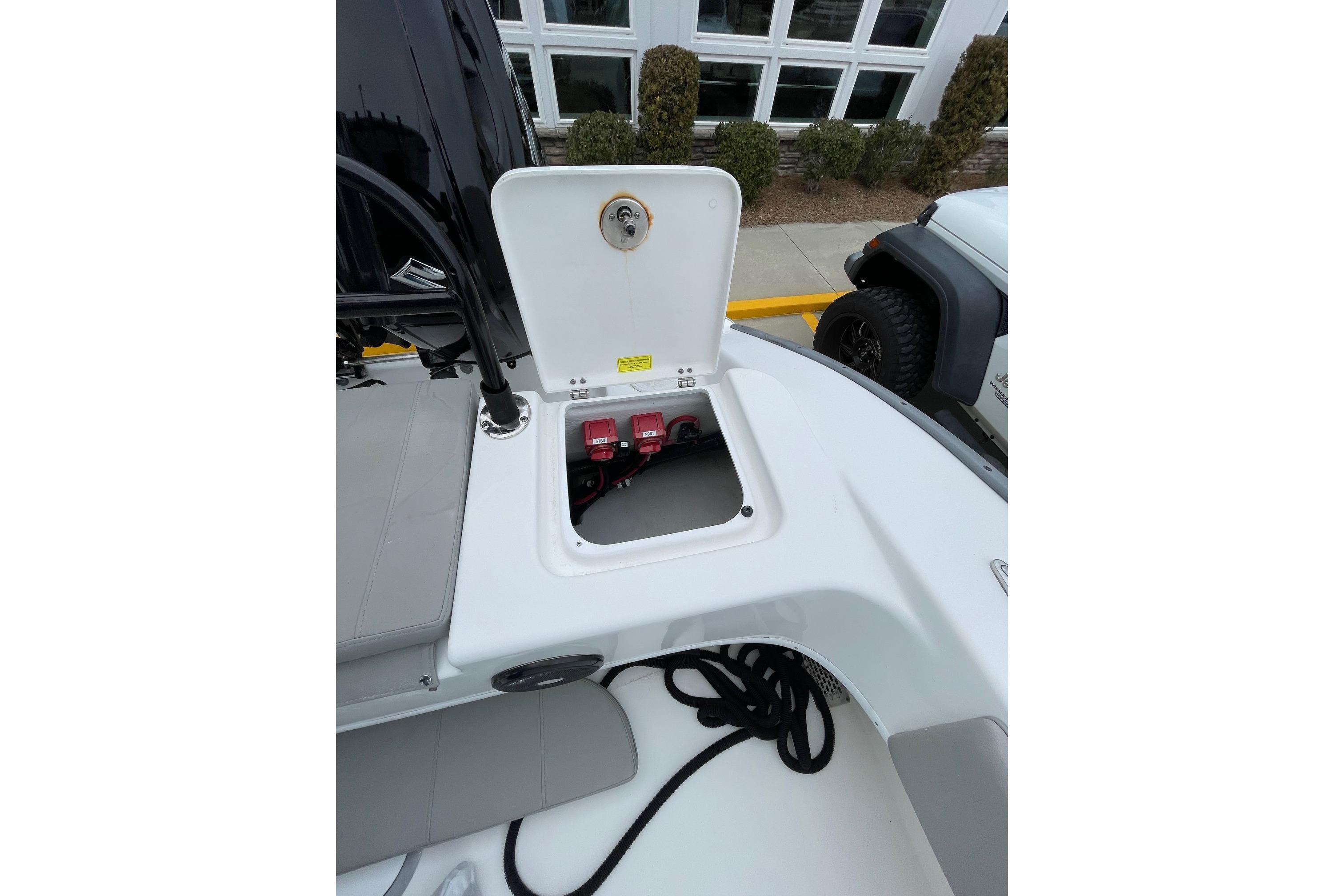 2023 Cape Horn 24 XS boat battery compartment with open hatch, showcasing interior components.