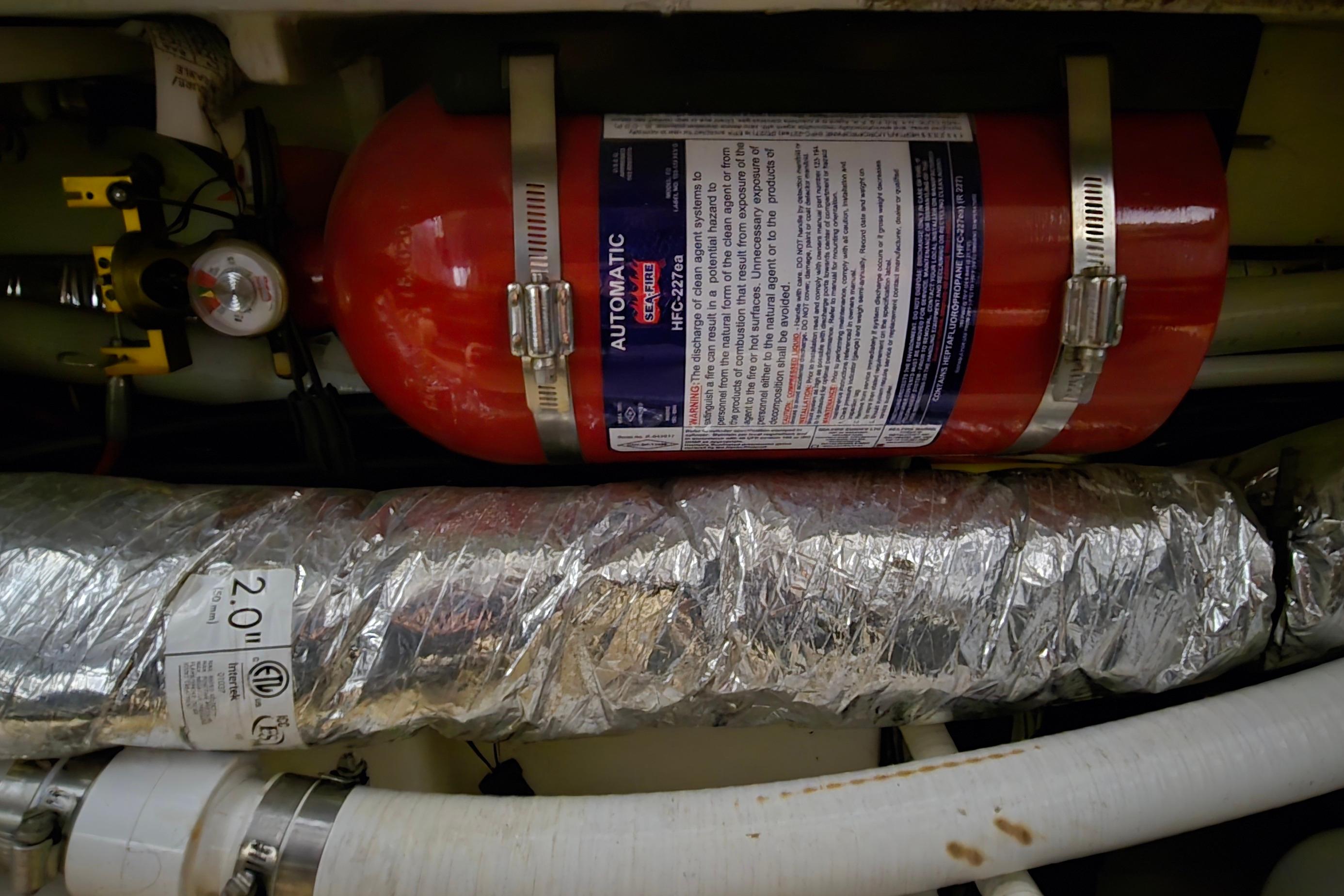 Engine compartment of 2018 Four Winns V355 with automatic fire extinguisher system.