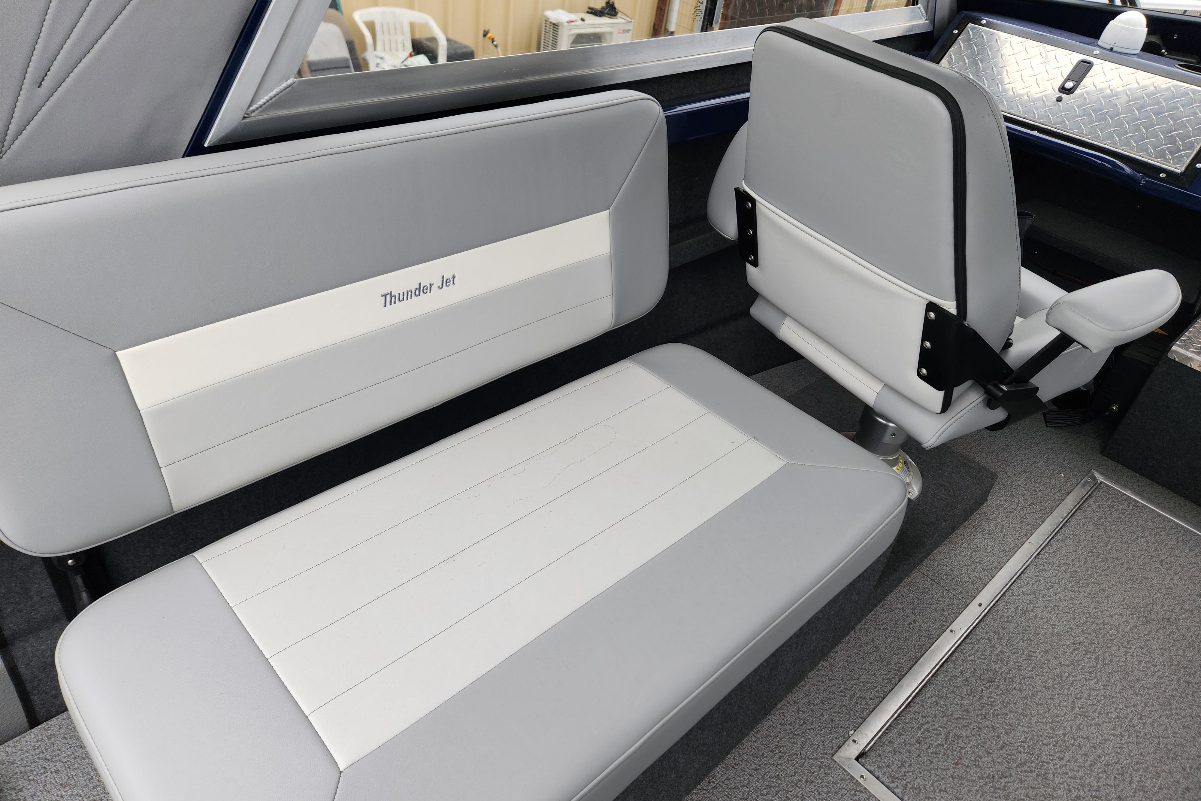 Interior seating of 2025 Thunder Jet 21 Chinook OS boat, featuring gray and white upholstery.
