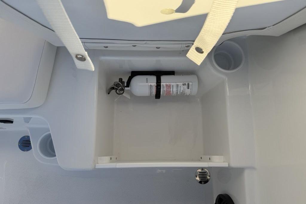 Storage compartment with fire extinguisher in 2026 Tahoe T16 boat.