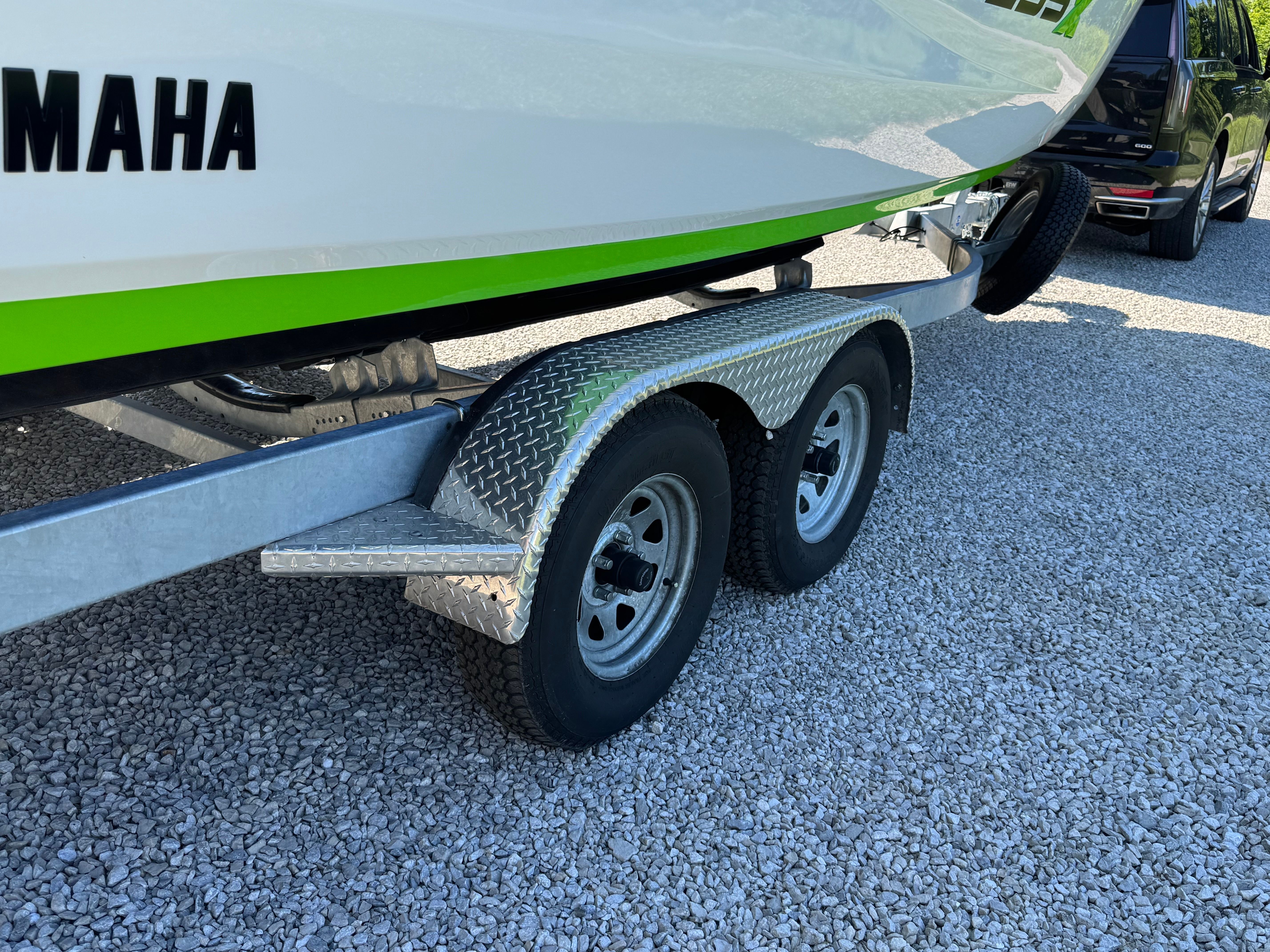A Yamaha 255XD boat on a dual-axle trailer.