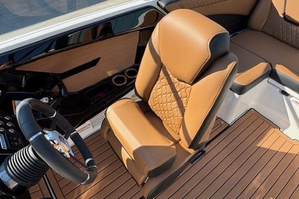 2026 Yamaha Boats 222SE interior with tan leather seating and modern steering wheel.