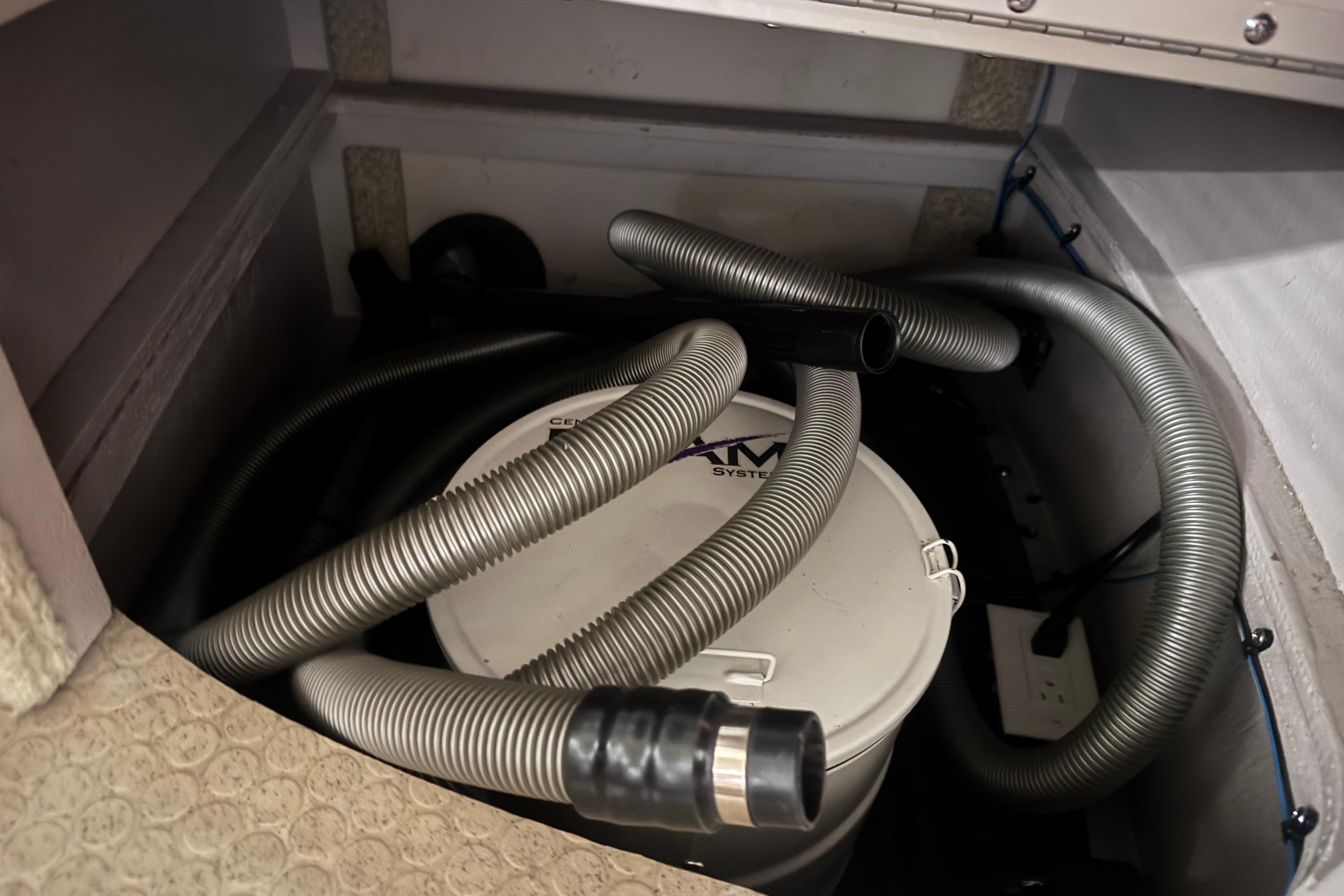 2004 Sea Ray 390 Motor Yacht vacuum system with hoses in storage compartment.