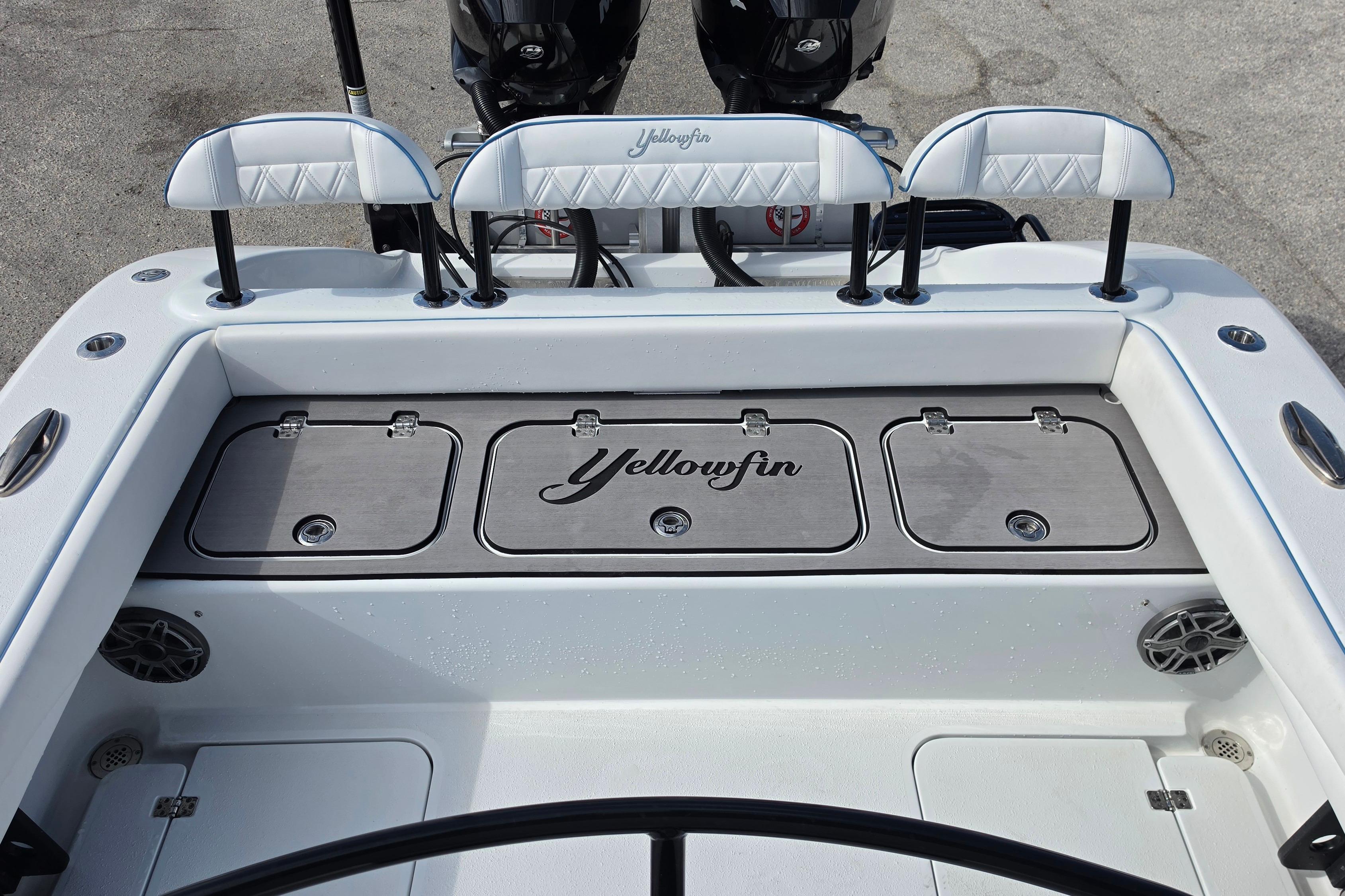 2025 Yellowfin 26 Hybrid boat interior with storage compartments and seating.