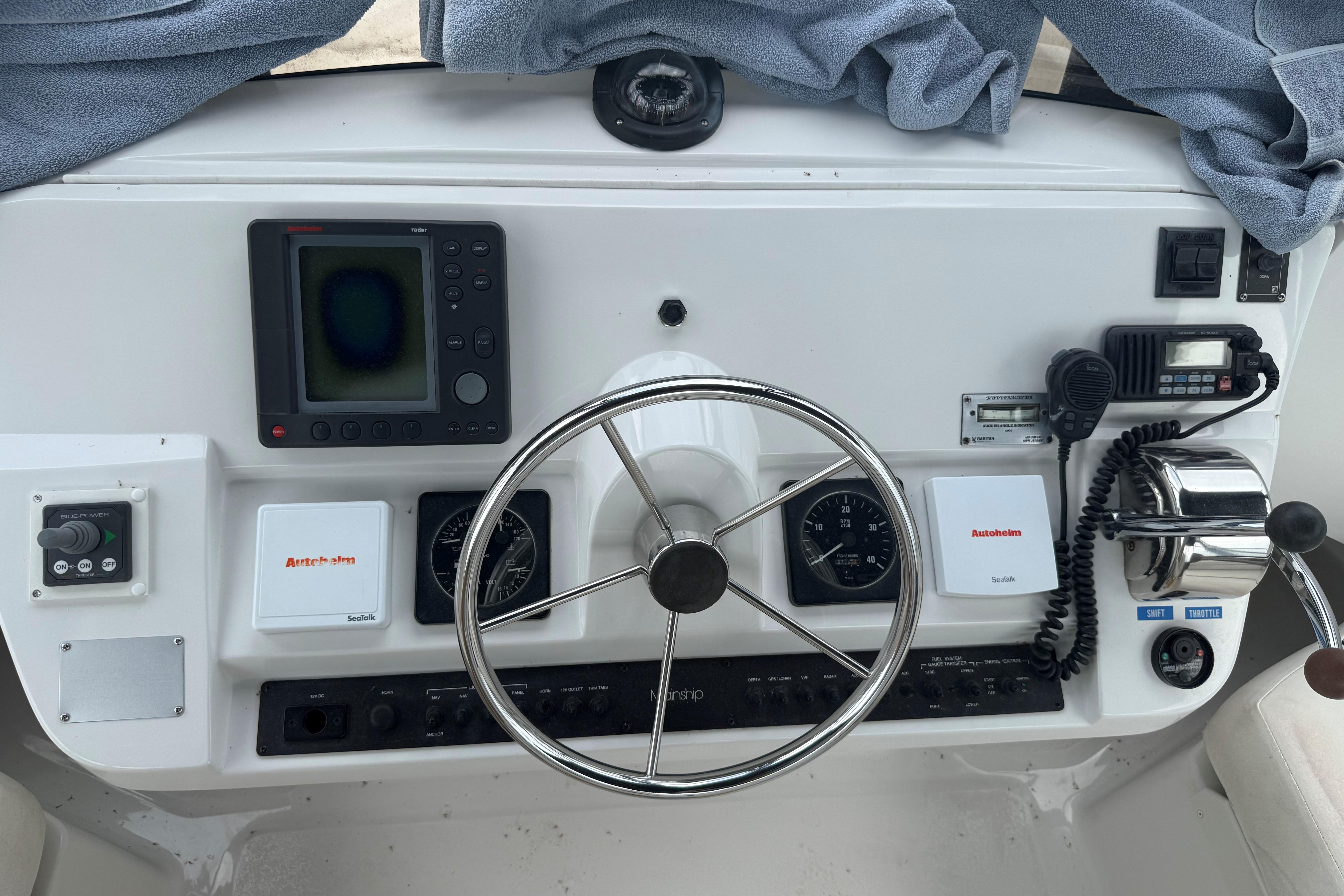 1999 Mainship 350 Trawler helm with navigation instruments and steering wheel.