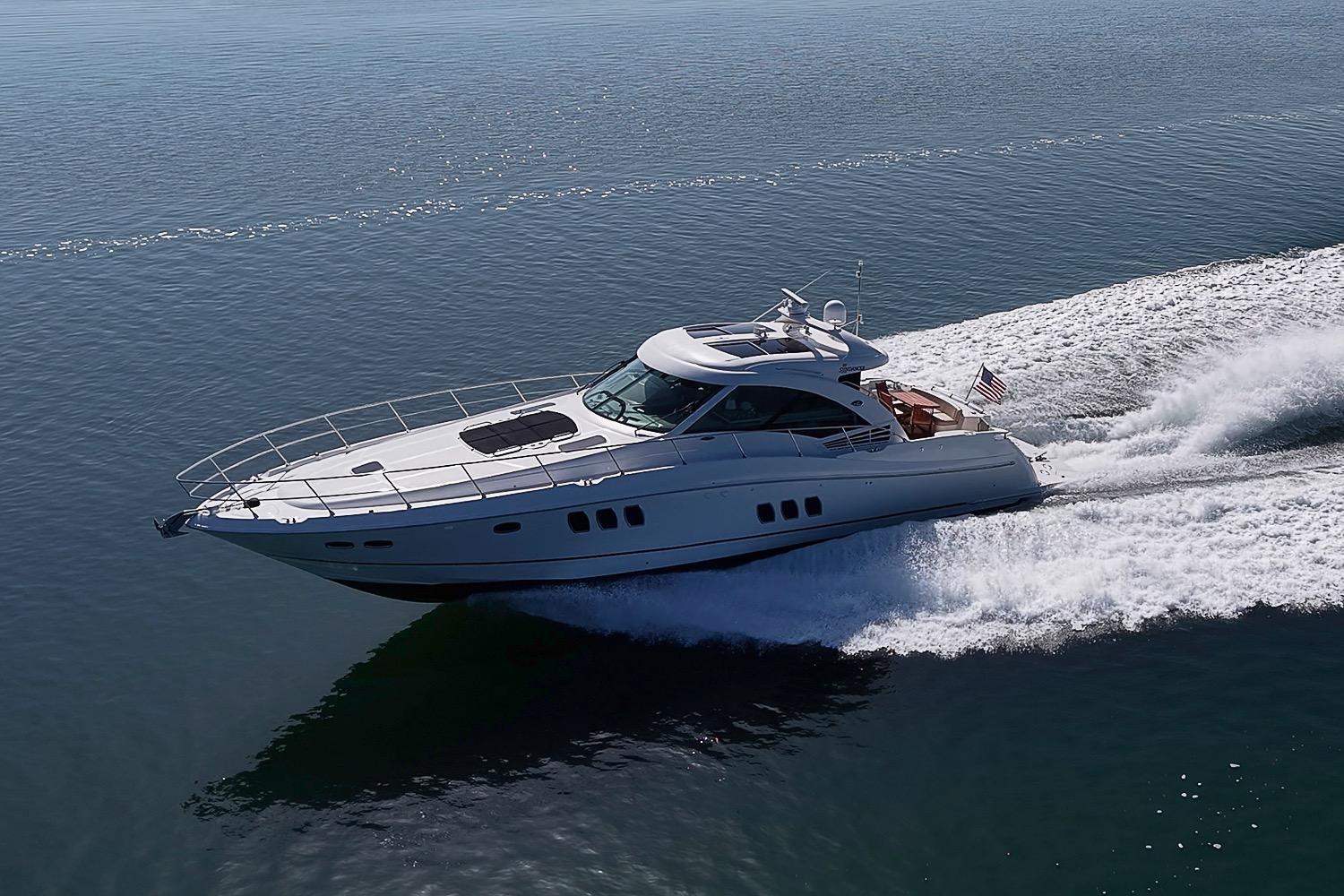 2008 Sea Ray 60 Sundancer yacht cruising on open water, creating a dynamic wake.