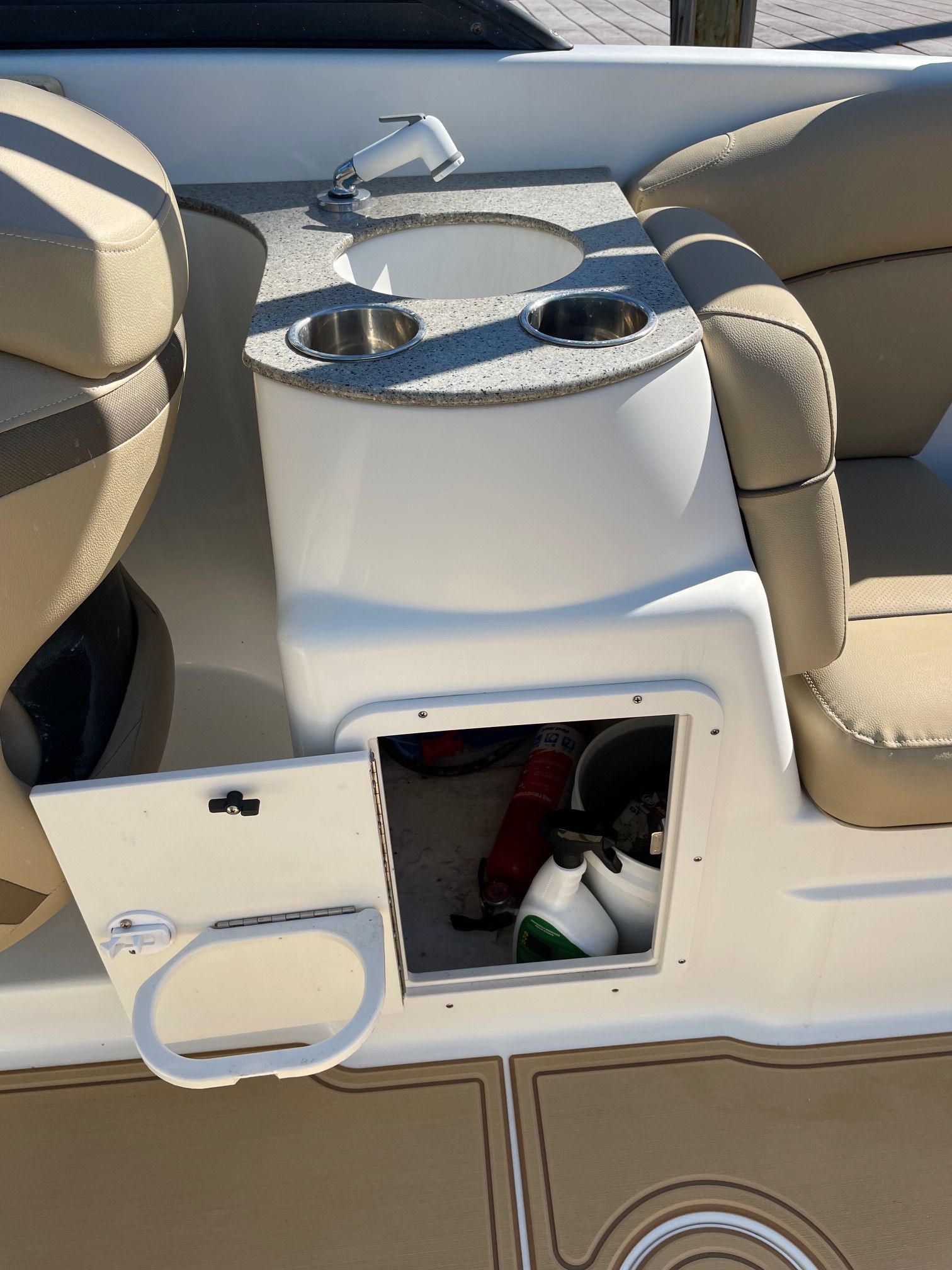 2019 NauticStar 243DC Sport Deck with sink and storage compartment.