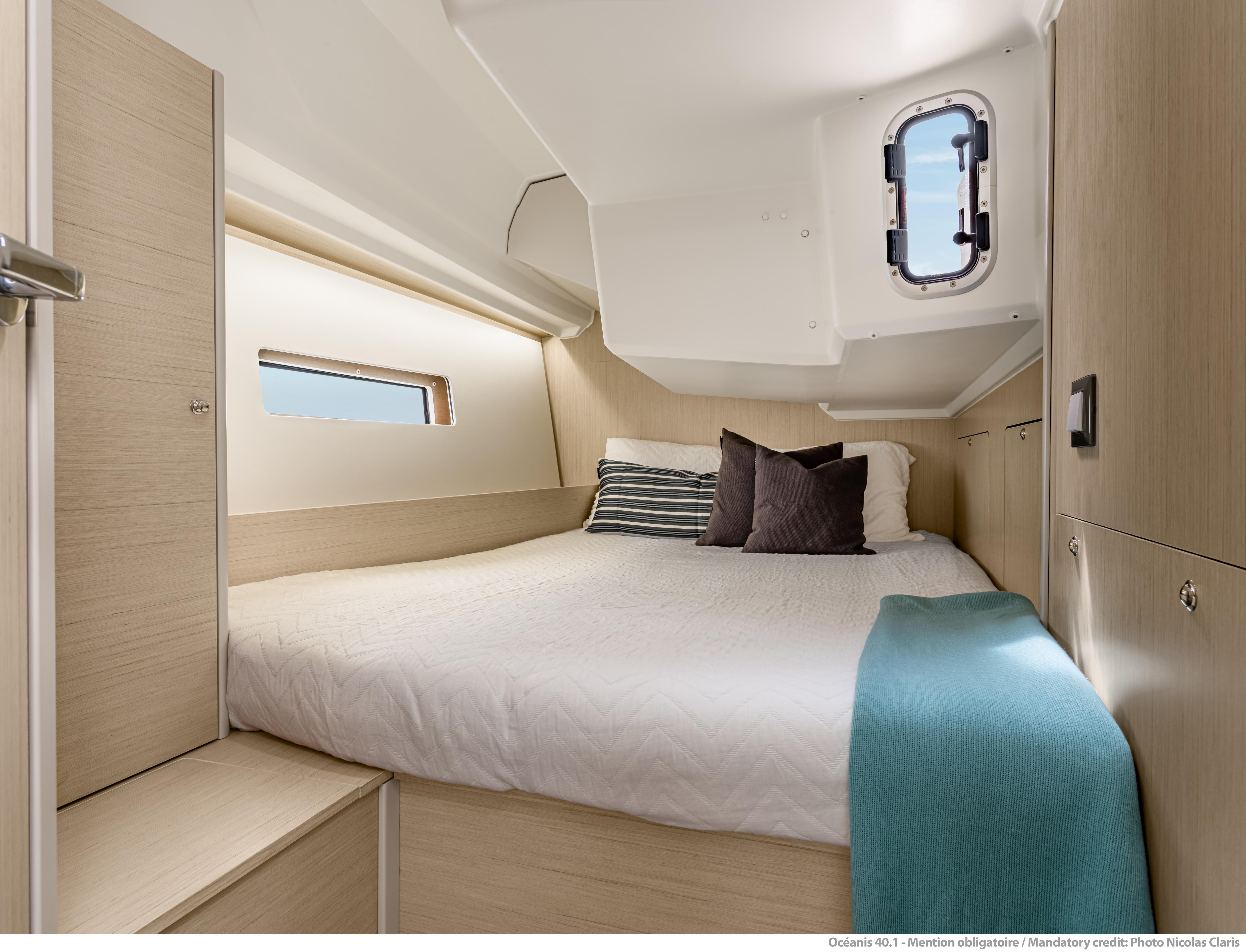 2025 Beneteau Oceanis 40.1 cabin interior with cozy bed and modern design.