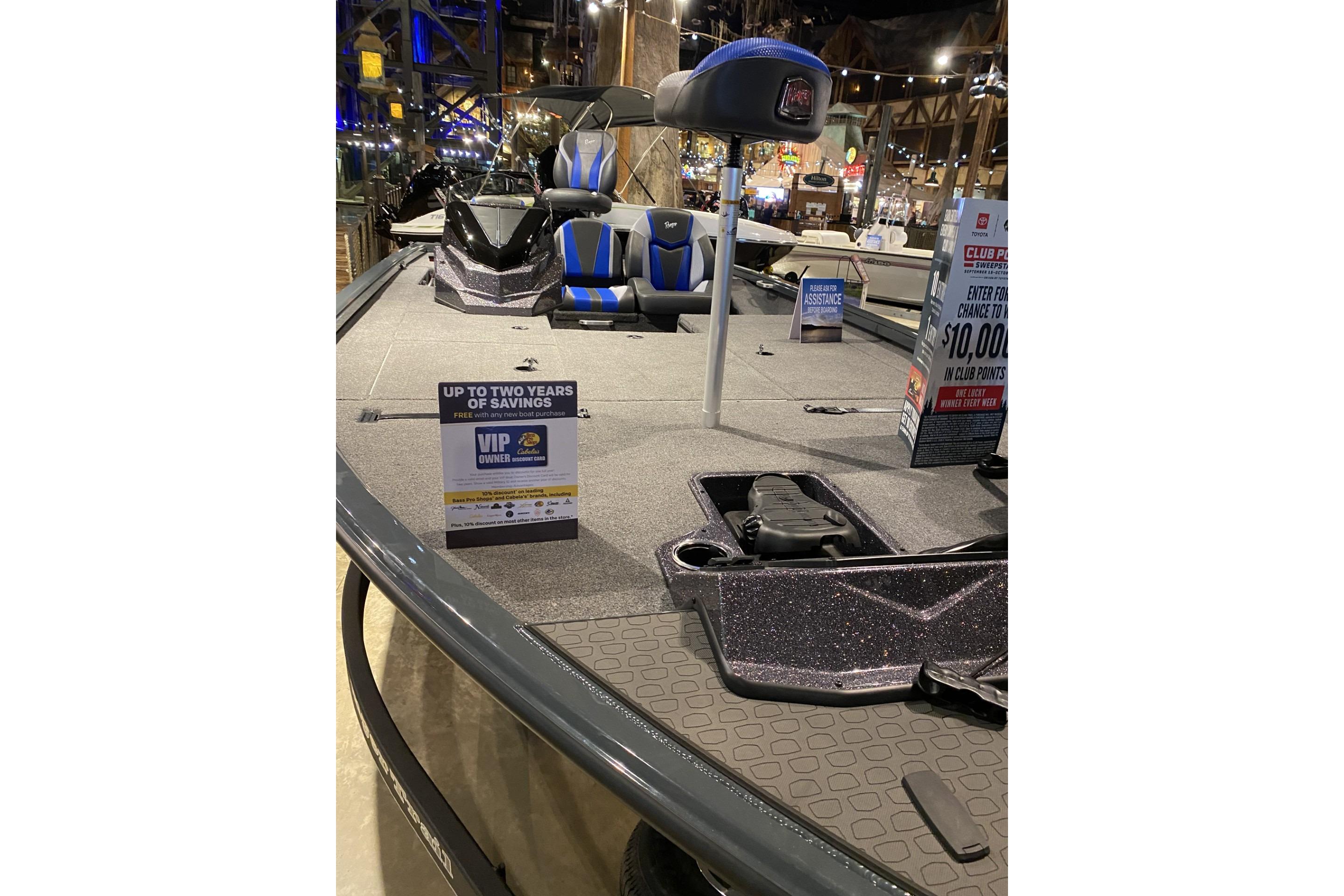 2025 Ranger ALPHA 208 boat on display with promotional signs and seating.