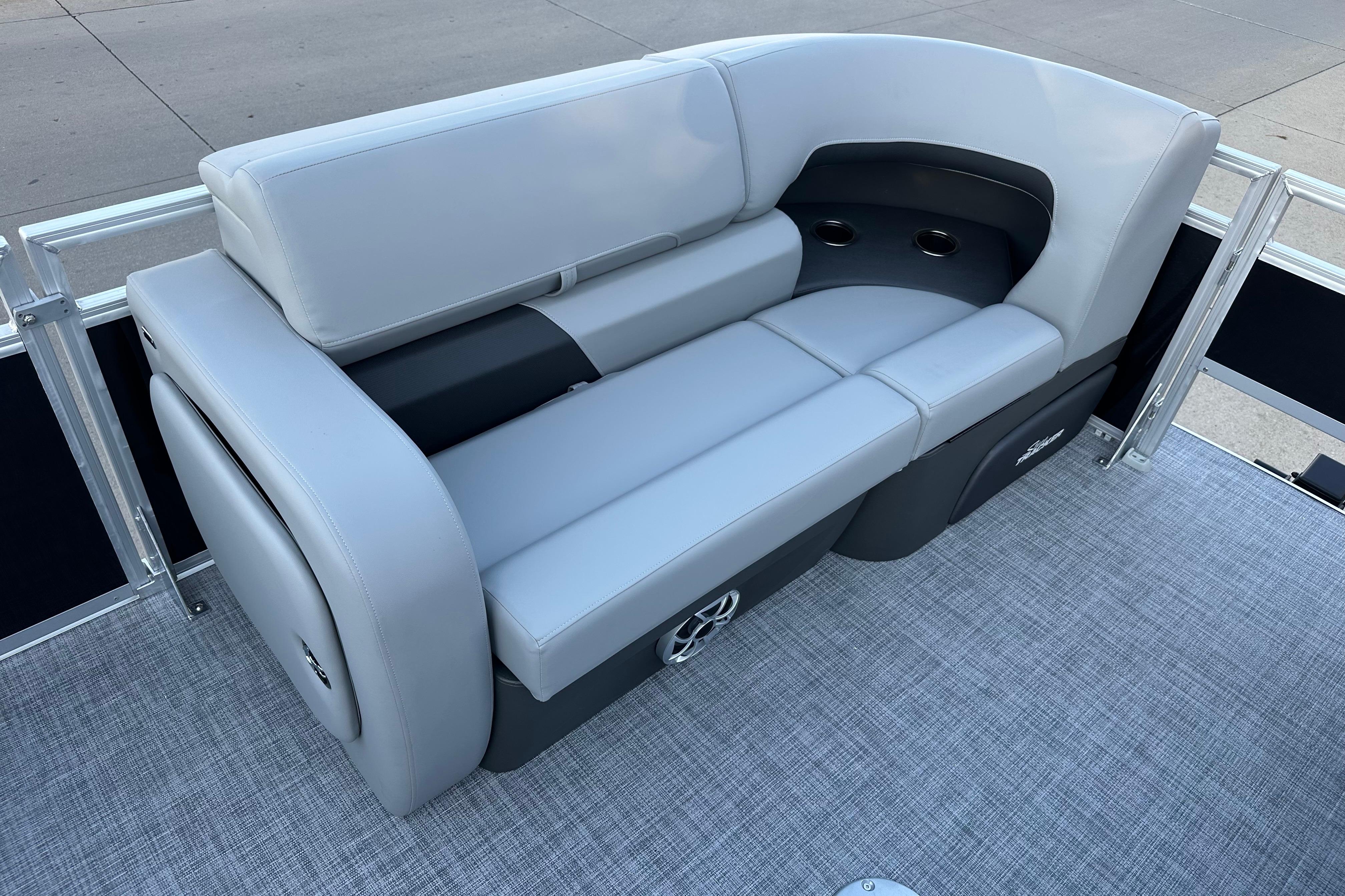 2026 Sun Tracker SportFish 22 DLX boat seating with cup holders and gray upholstery.