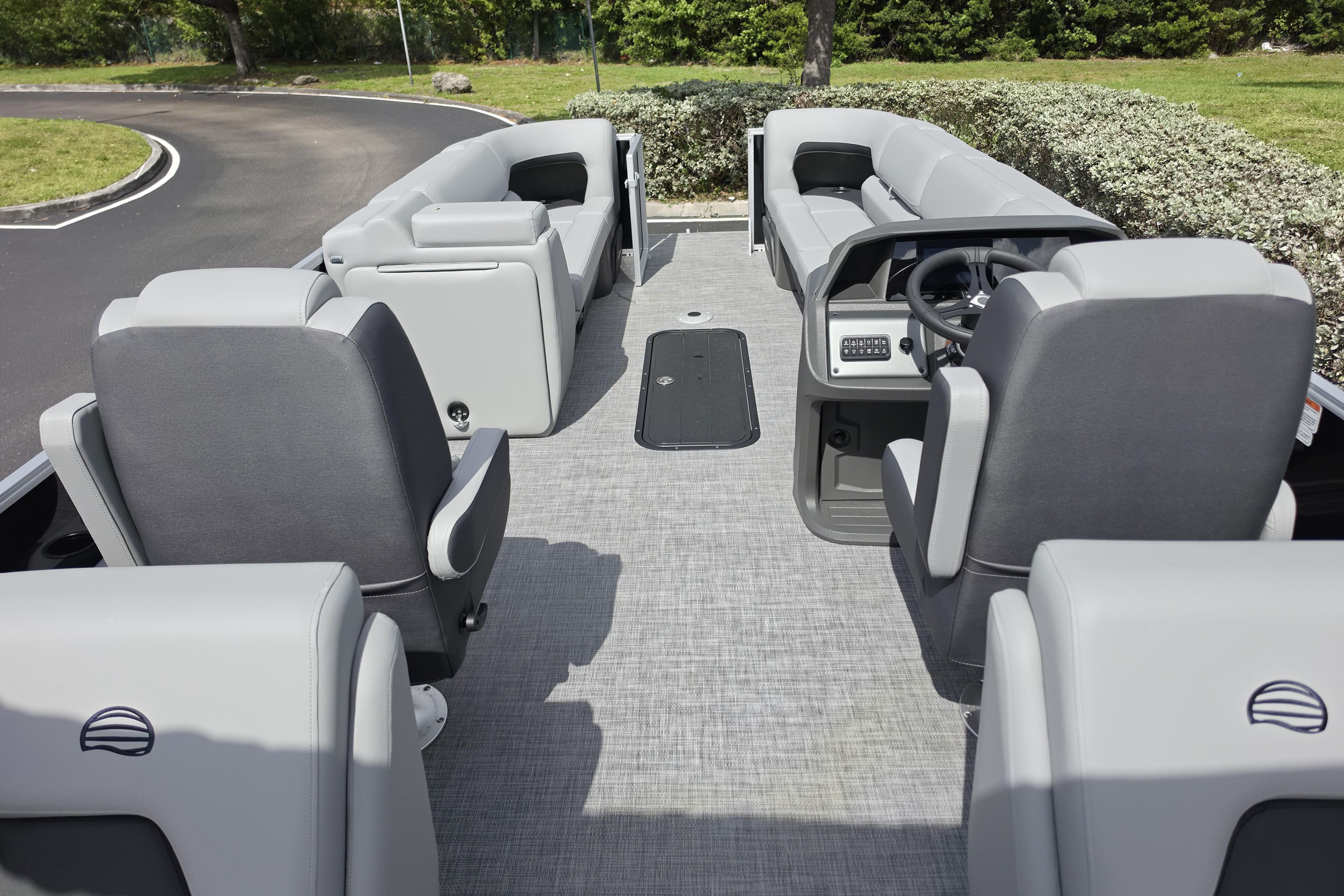 2026 Sun Tracker Party Barge 24 XP3 interior with gray seating and steering console.