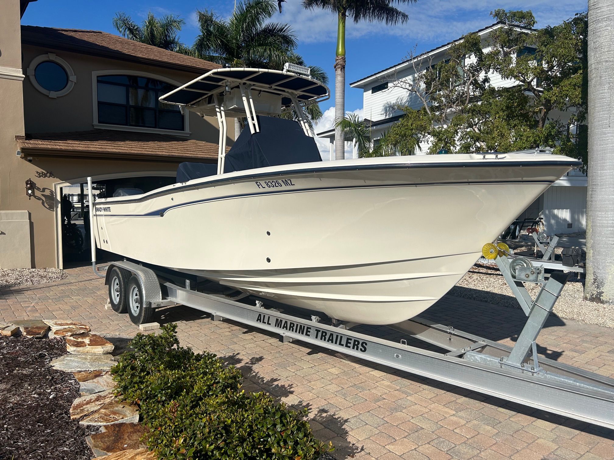 2006 Grady-White Chase 273 boat on trailer in front of house.