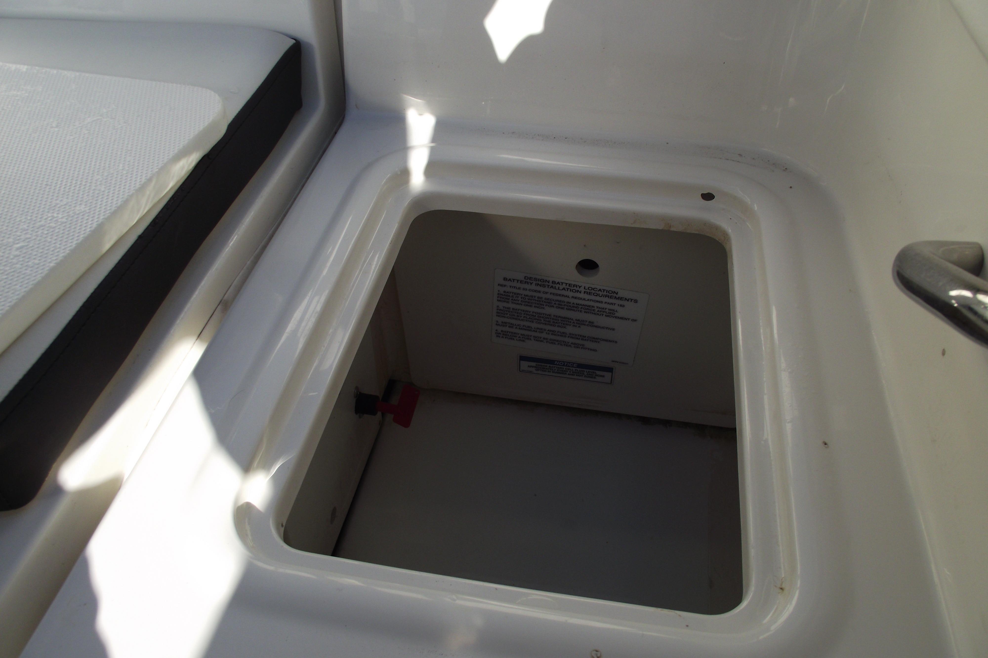 2022 Bayliner VR4 Bowrider OB storage compartment, open and empty.