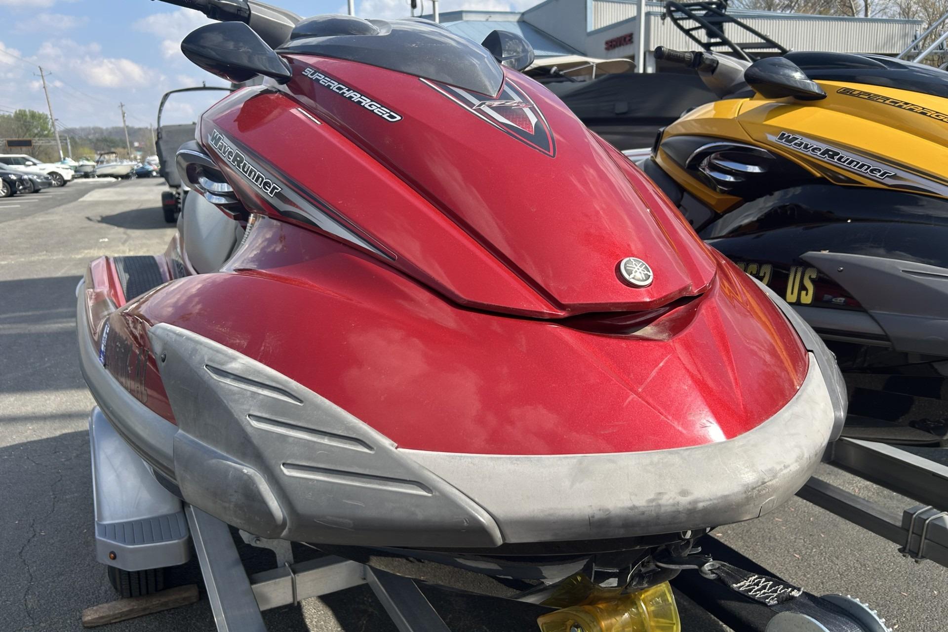2011 Yamaha WaveRunner FZS in red, parked on a trailer, side view.