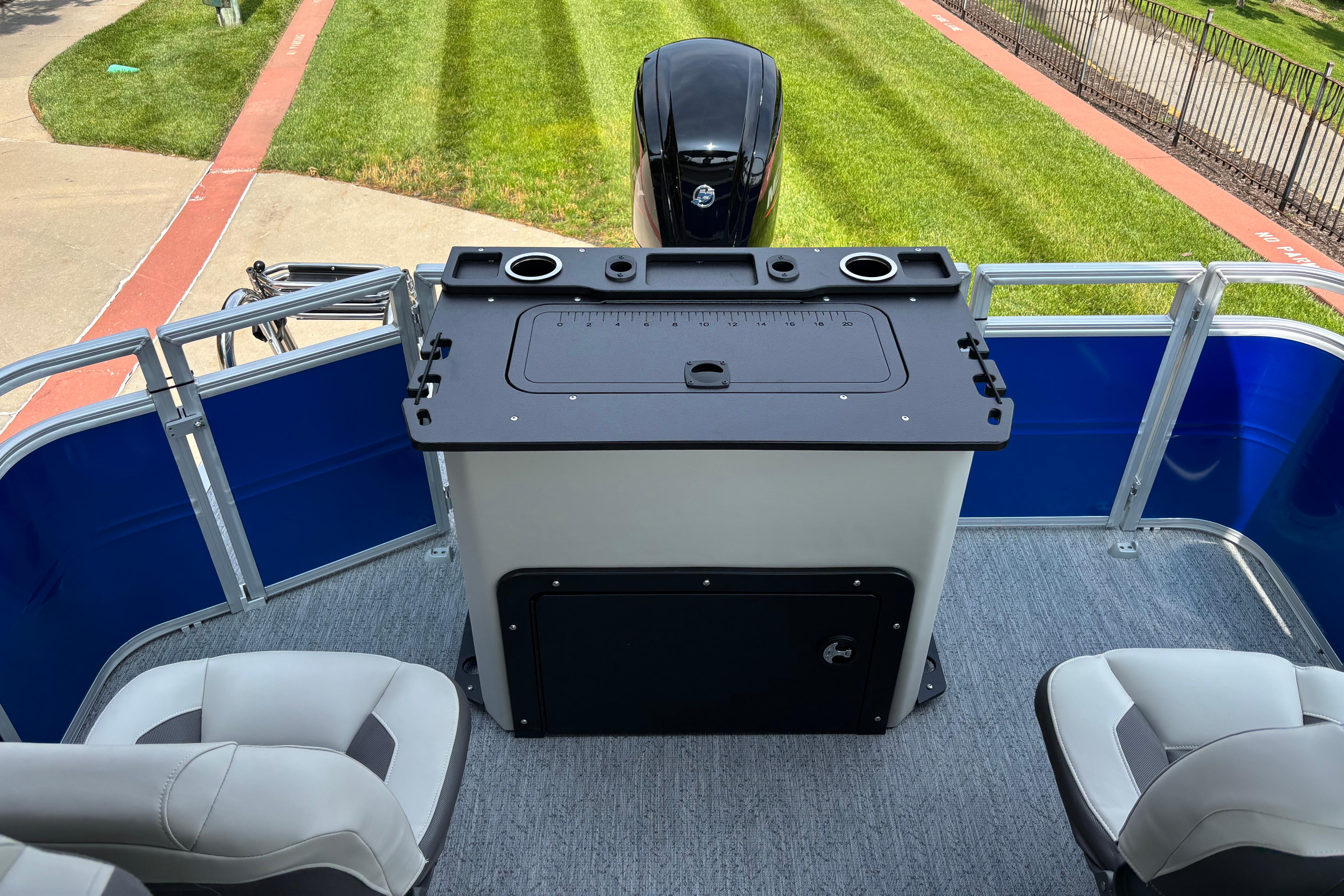 2026 Sun Tracker Fishin' Barge 20 DLX interior with seating and control panel.