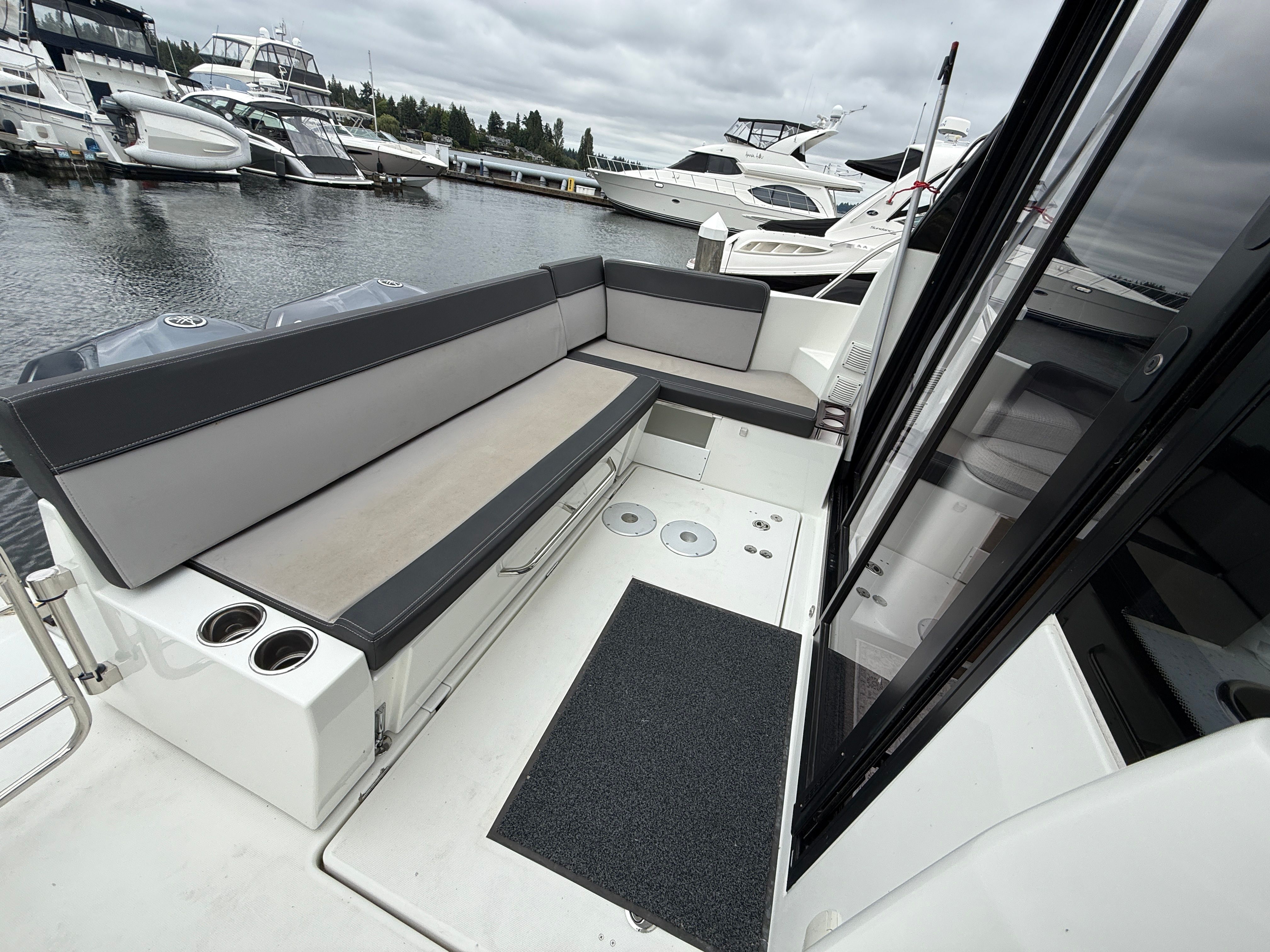 The image shows the cockpit of a 2021 Jeanneau NC 1095 with gray upholstery.