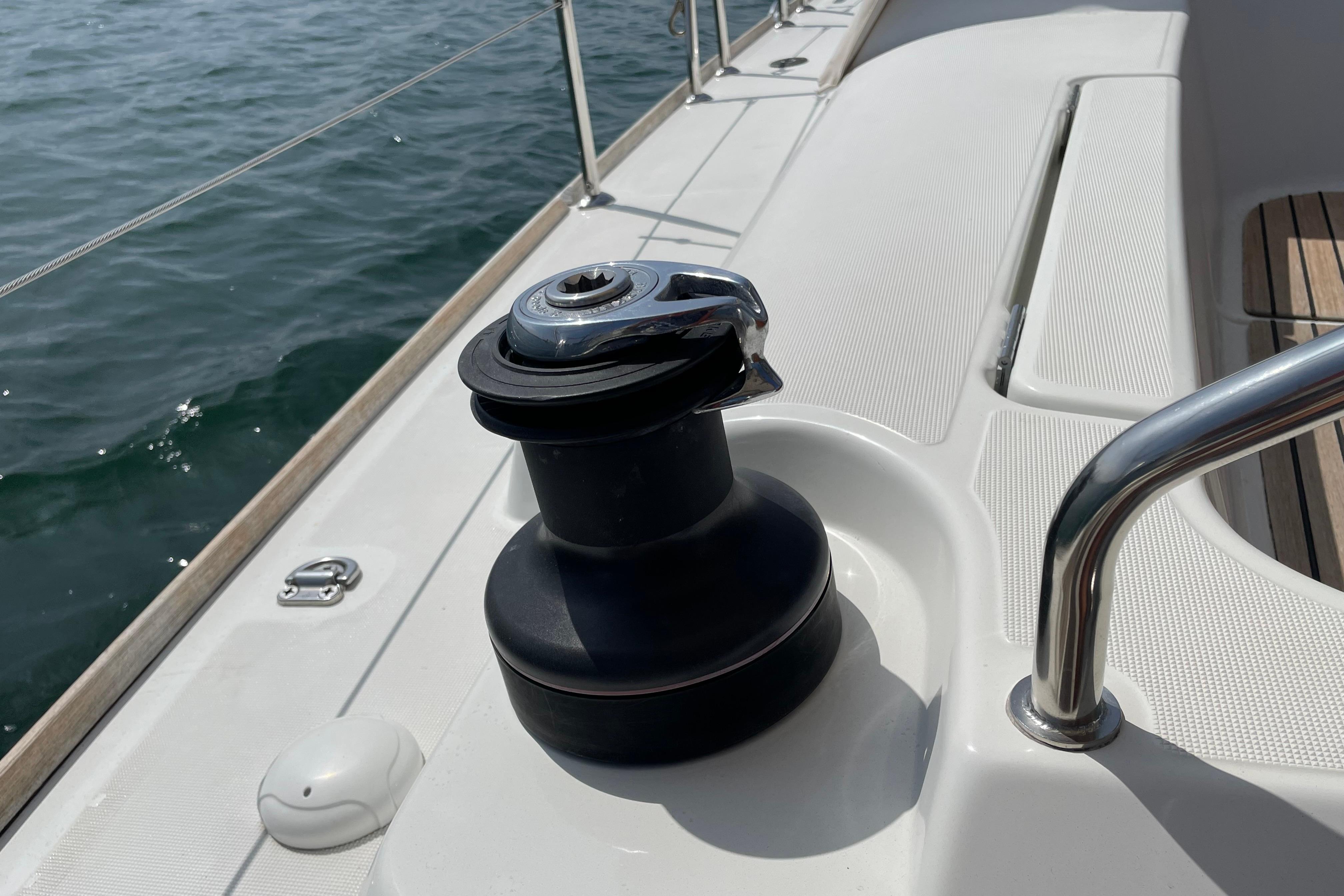 Winch on Jeanneau Sun Odyssey 39 DS sailboat deck, 2007 model, near water.