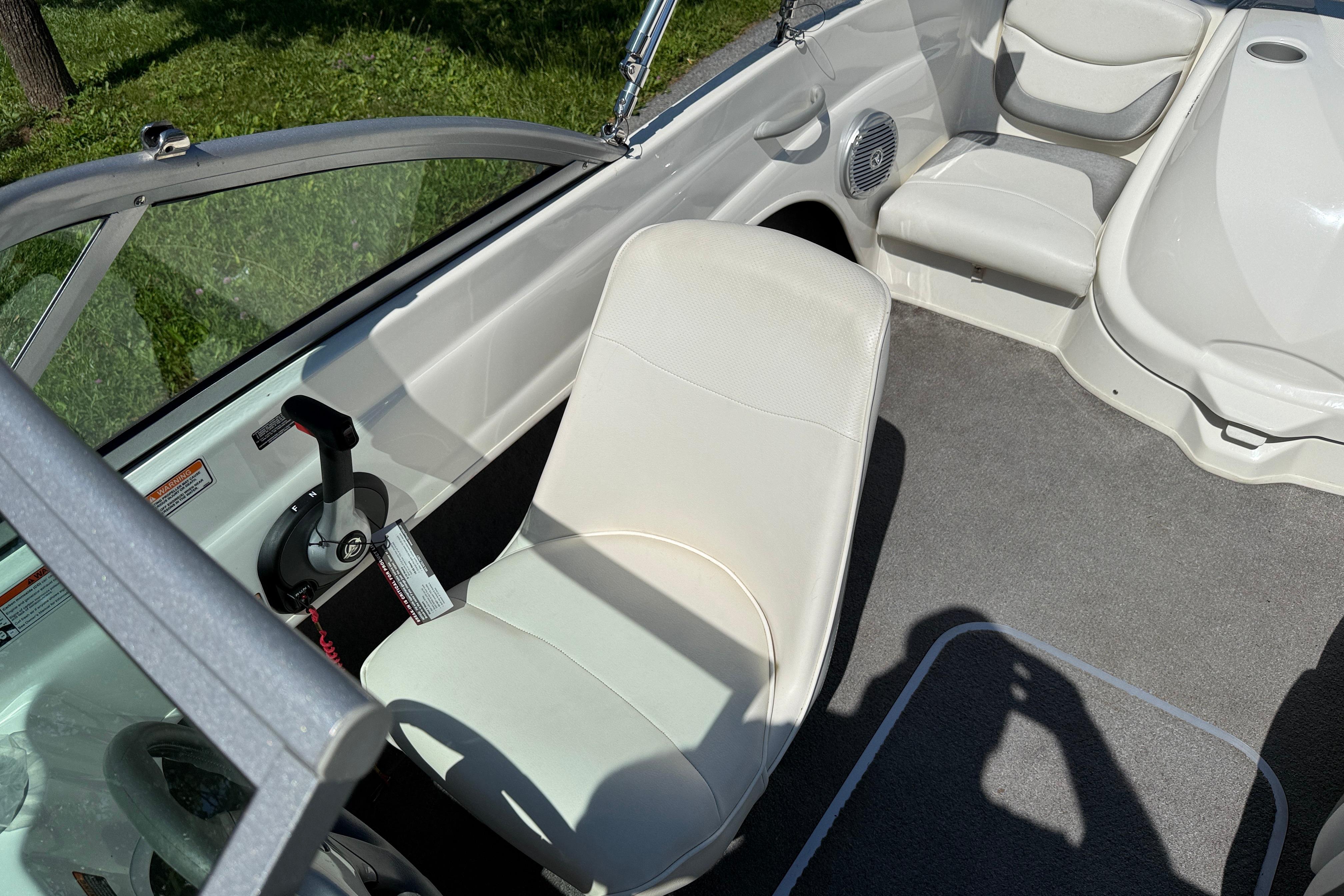 2009 Bayliner 175 boat interior with white seating and steering controls.