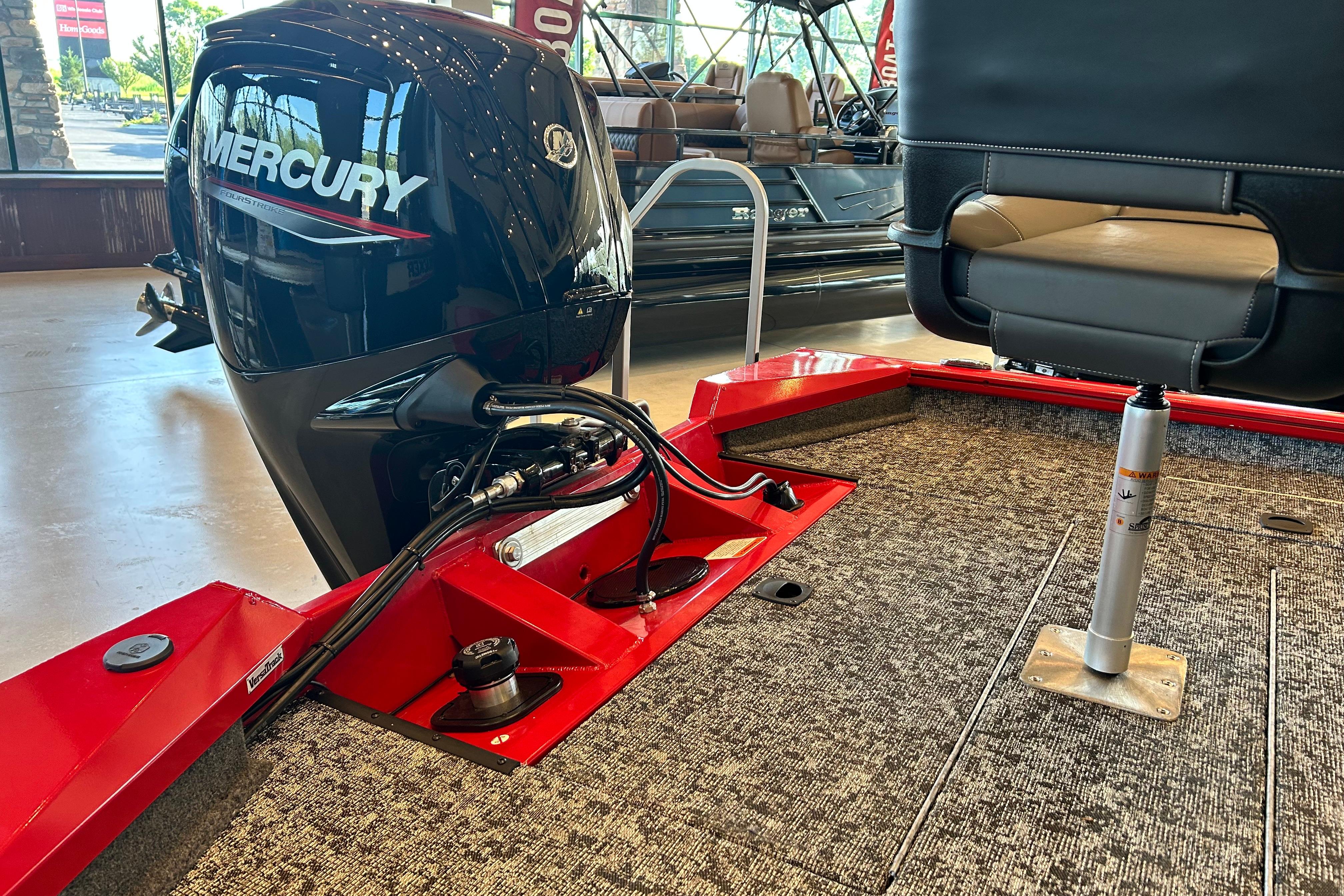 2026 Tracker Pro Team 175 boat with Mercury engine in showroom.