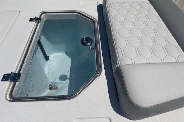 2026 Mako 18 Pro Skiff boat interior with livewell and cushioned seating.