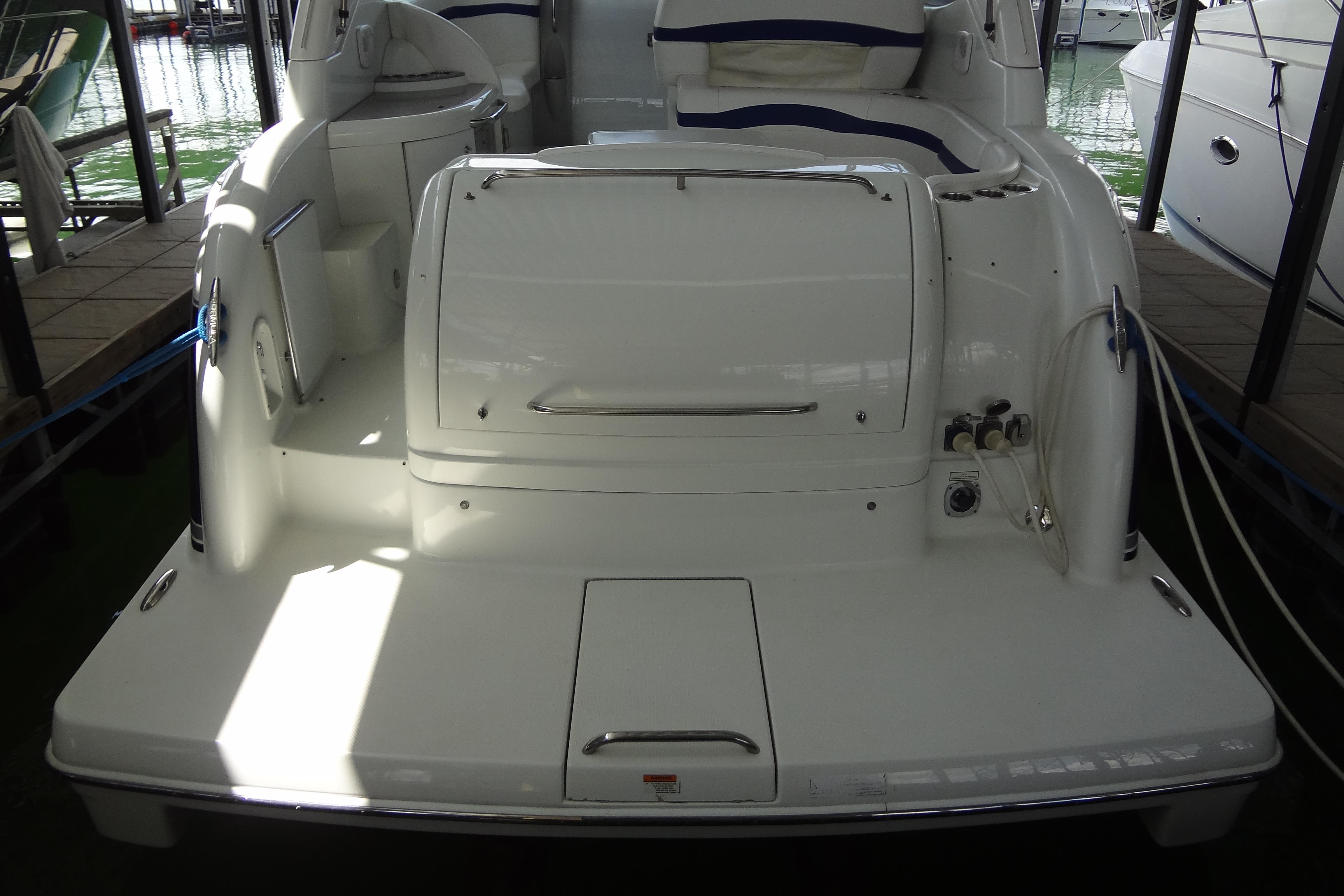 2007 Formula 34 Performance Cruiser boat docked, rear view showing deck and seating area.