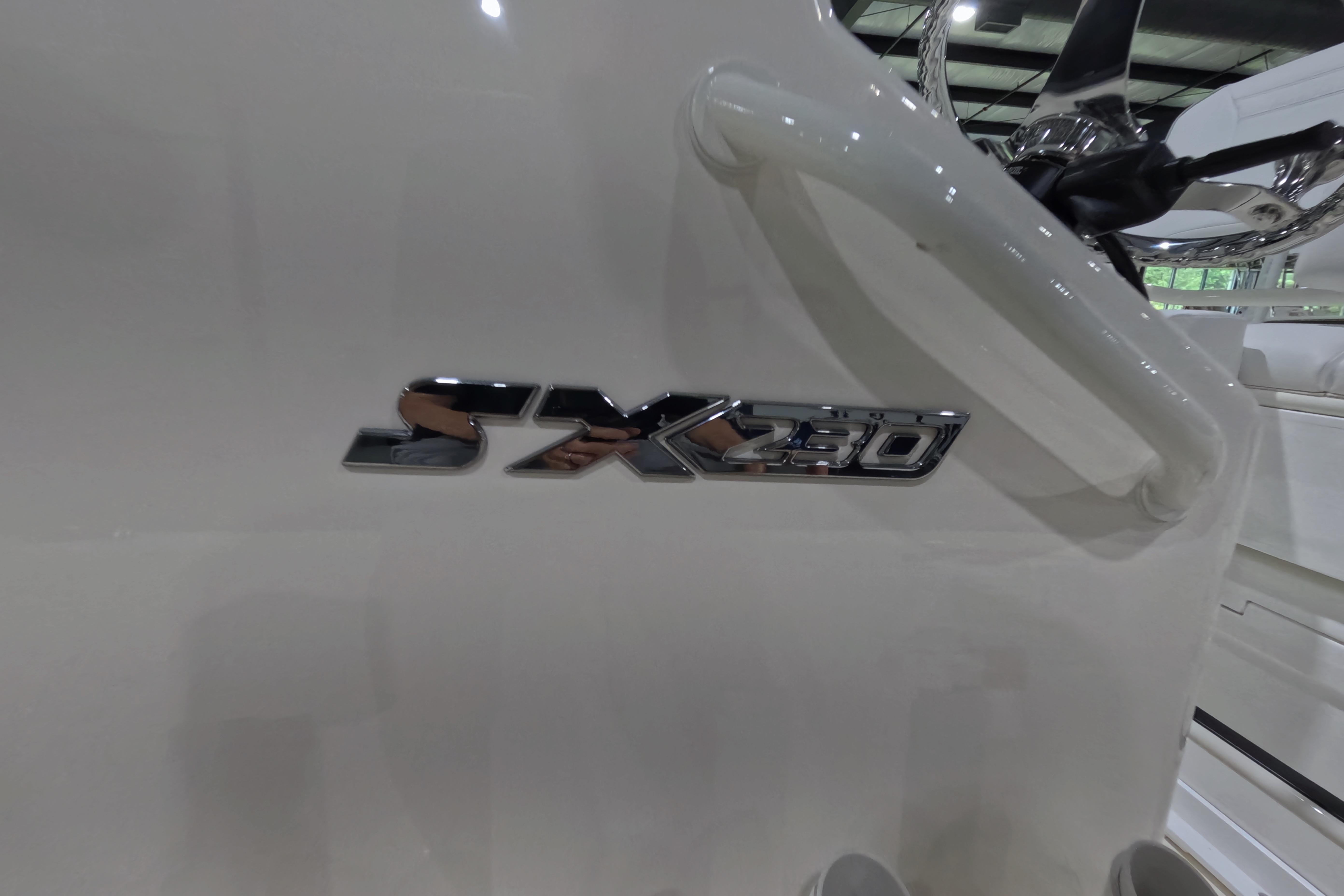 2026 Skeeter SX230 boat emblem on white surface, showcasing sleek design.