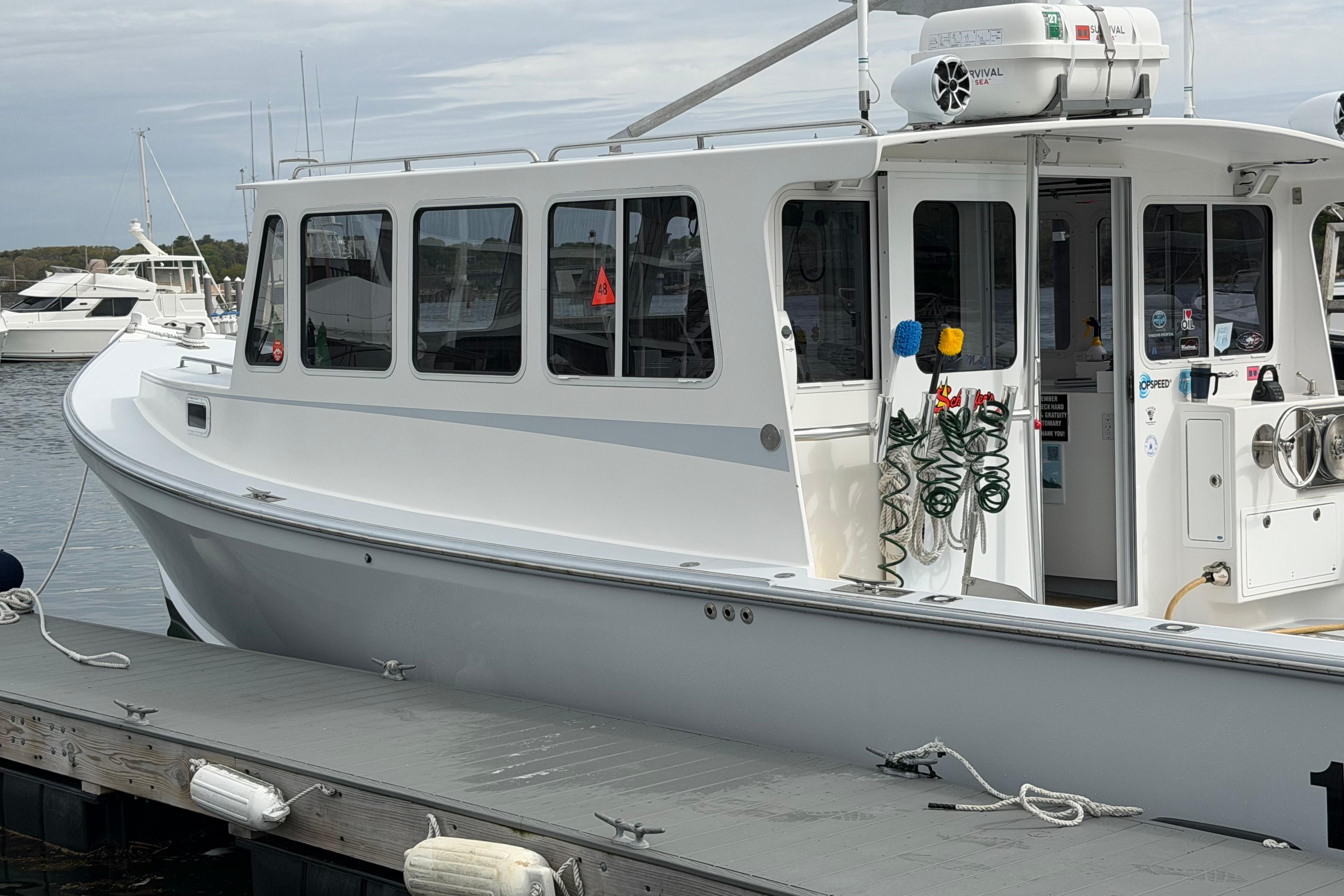 2018 H&H Marine Osmond Beal boat docked at a marina.