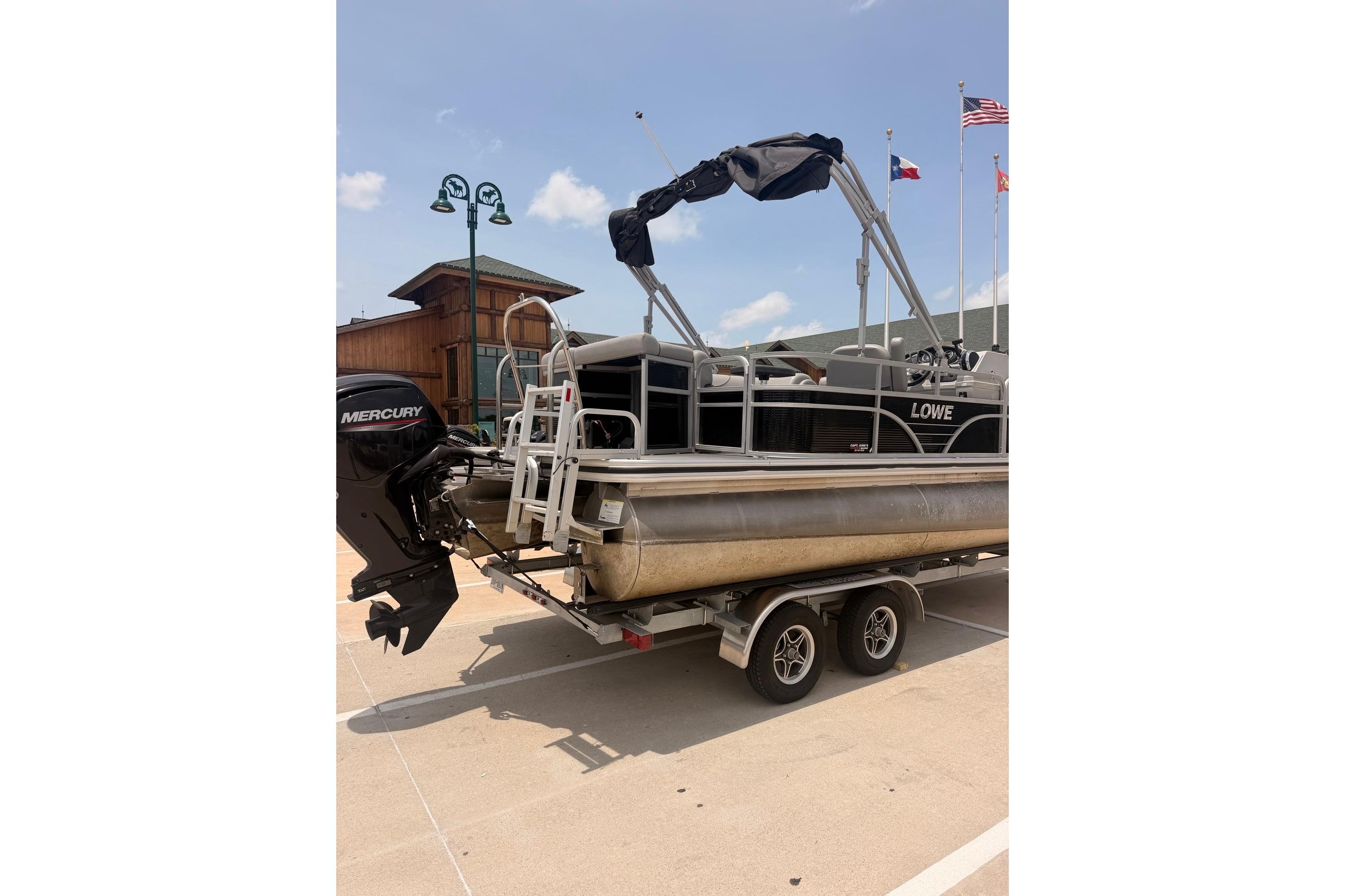 2021 Lowe SS 210 pontoon boat on trailer with Mercury outboard motor.