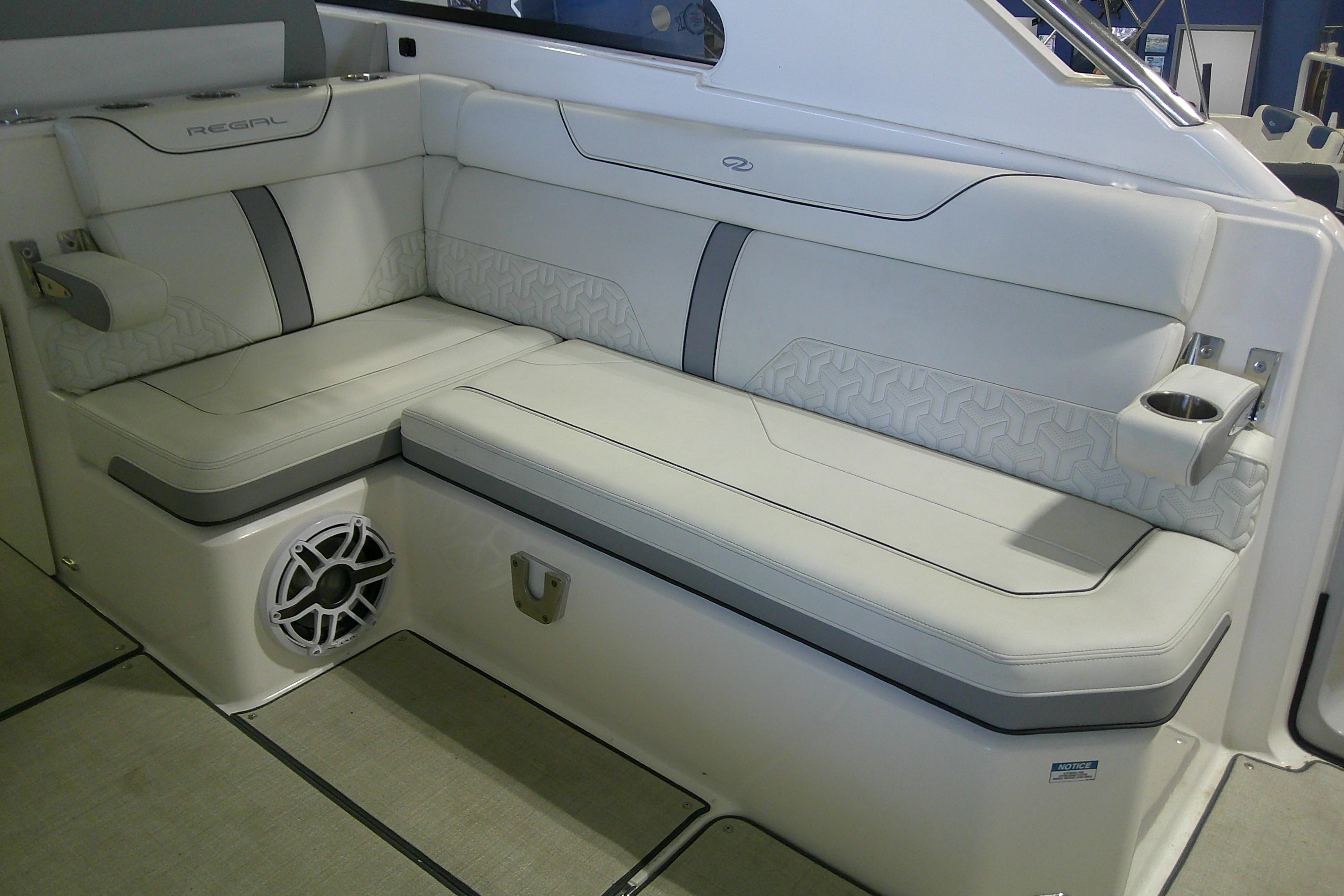 2023 Regal LX36 boat interior with luxurious white seating and integrated speaker system.