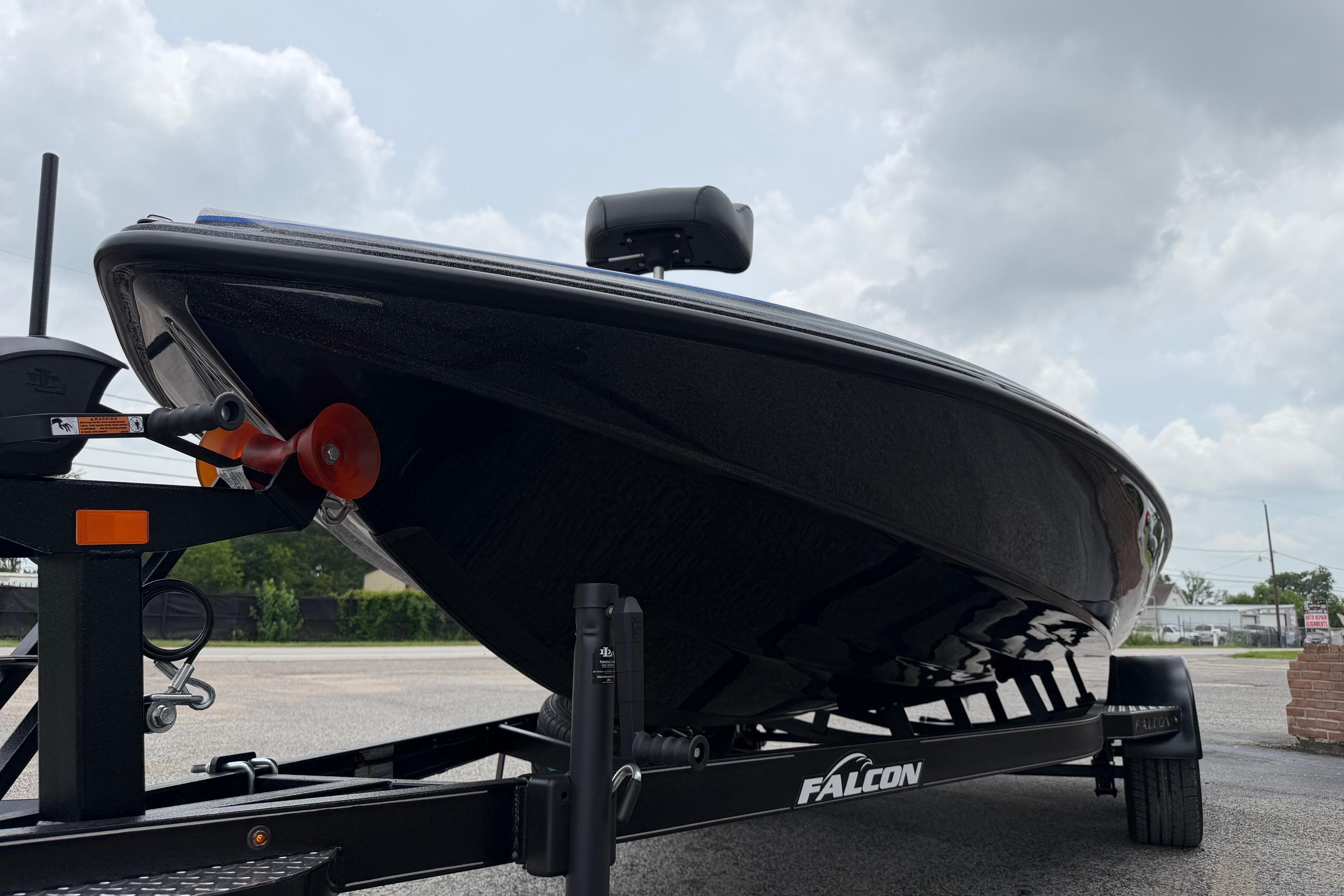 2027 Falcon F20 PREDATOR boat on trailer, sleek design under cloudy sky.