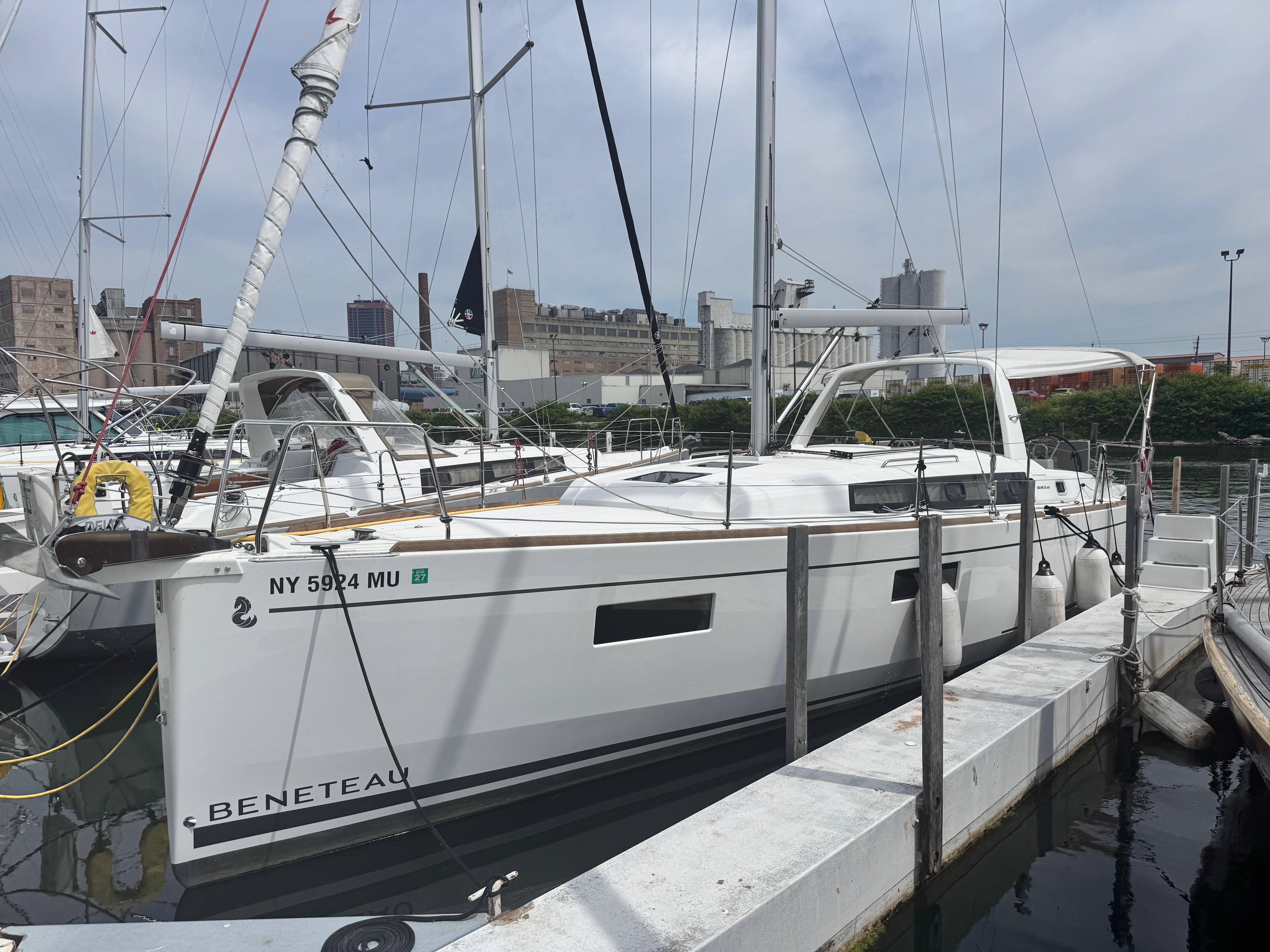 2023 Beneteau Oceanis 38.1 sailboat docked at marina, side view.
