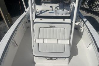 2016 Yamaha Boats 190 FSH Sport interior with white seating and steering console.