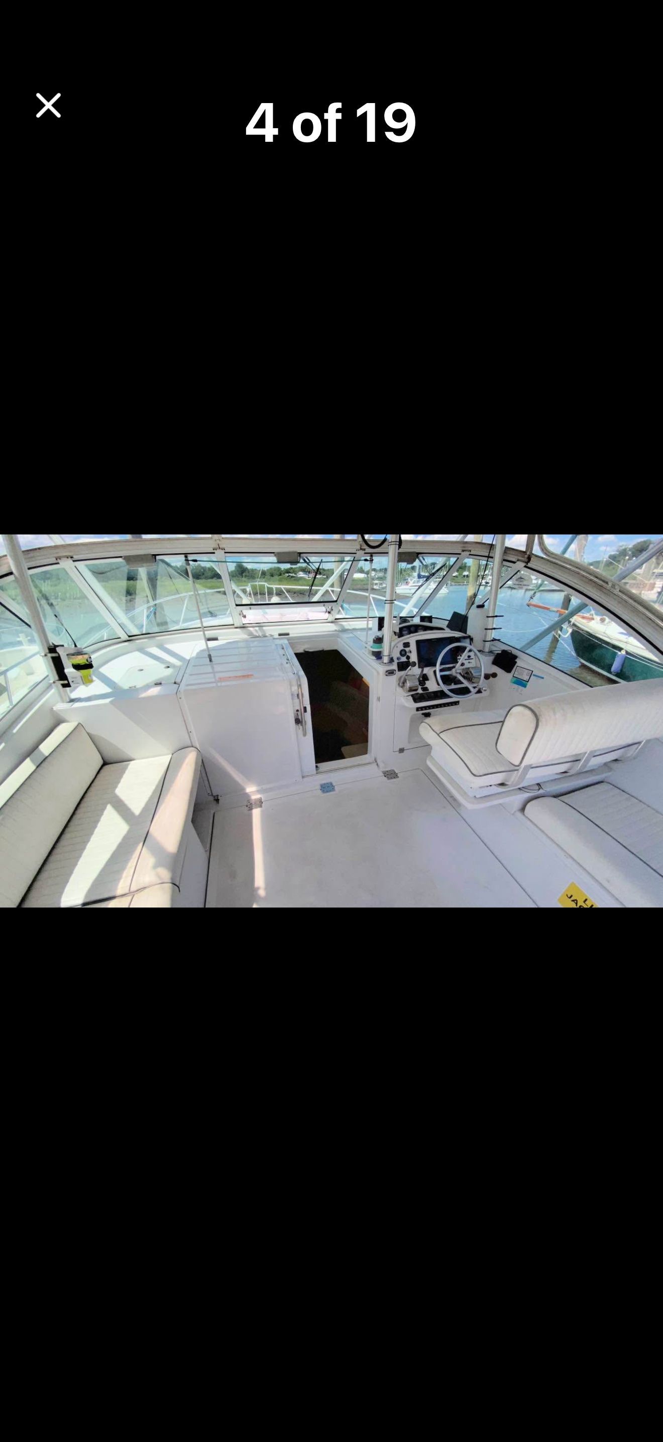 Interior view of a 1999 Luhrs Sx36 boat with seating area and helm station.