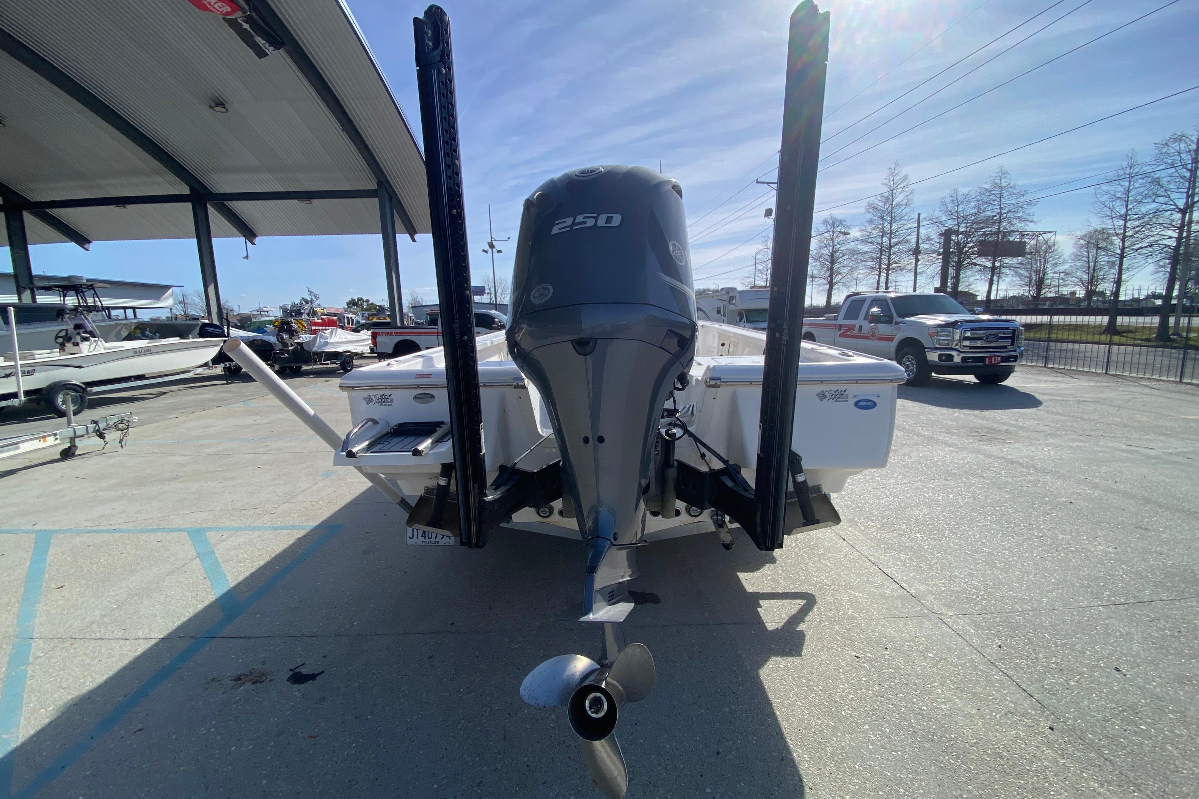 2023 Tidewater 2410 Bay Max boat with powerful 250 engine, parked outdoors.