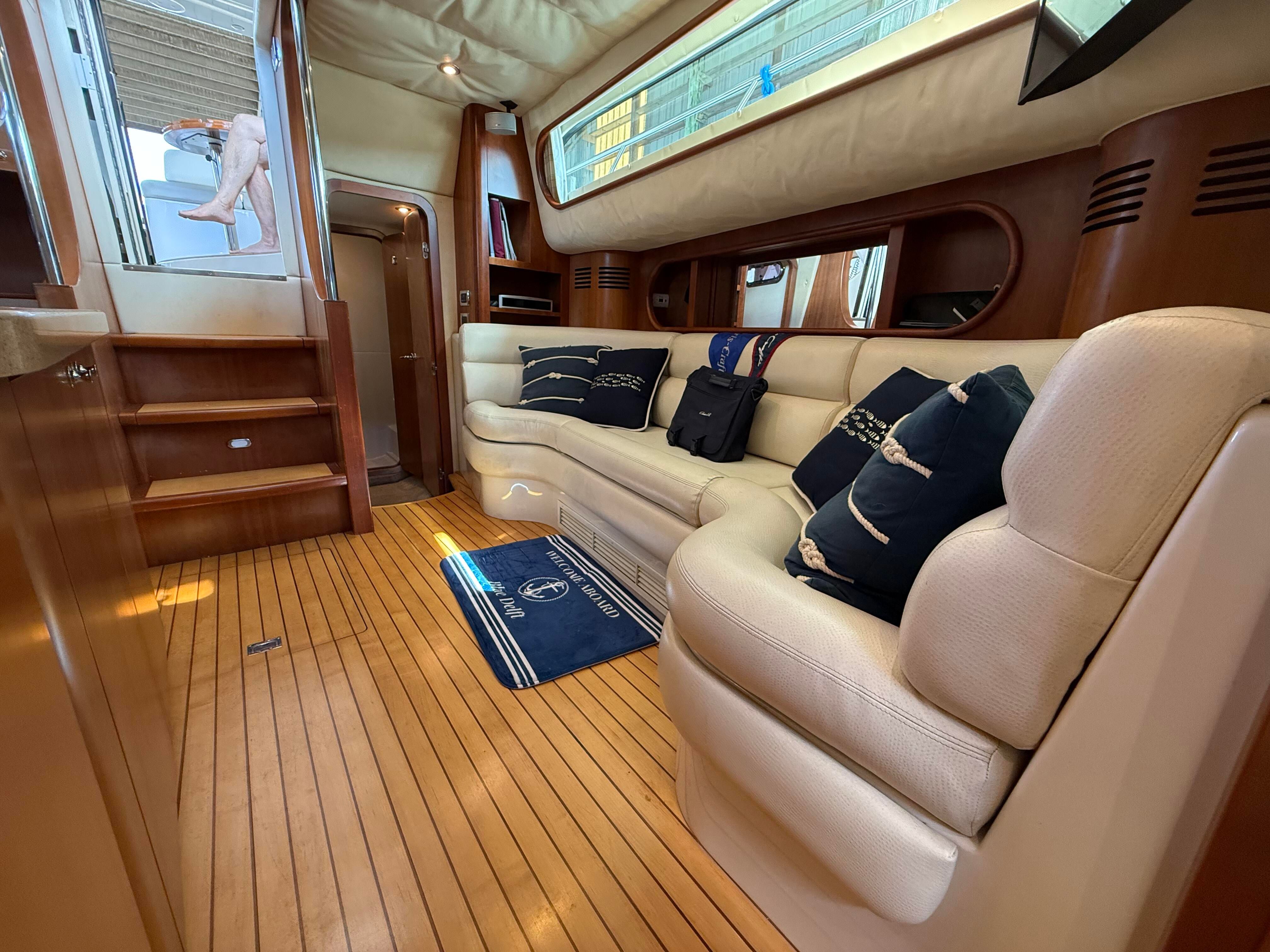 Interior of a 2007 Chris-Craft Roamer 40 with elegant wood flooring and comfortable white sofas.