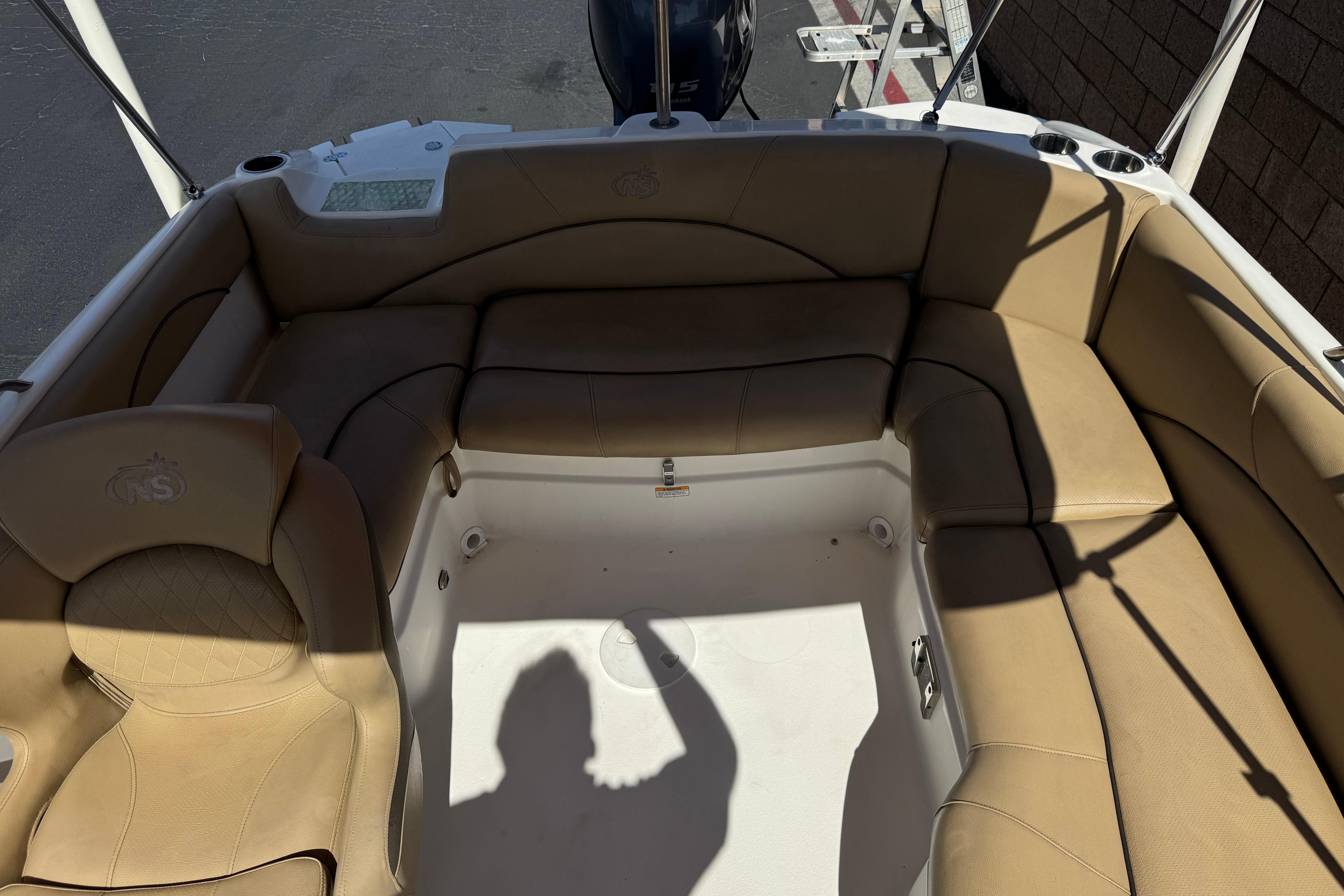 2020 NauticStar 203 SC boat interior with tan seating and spacious layout.