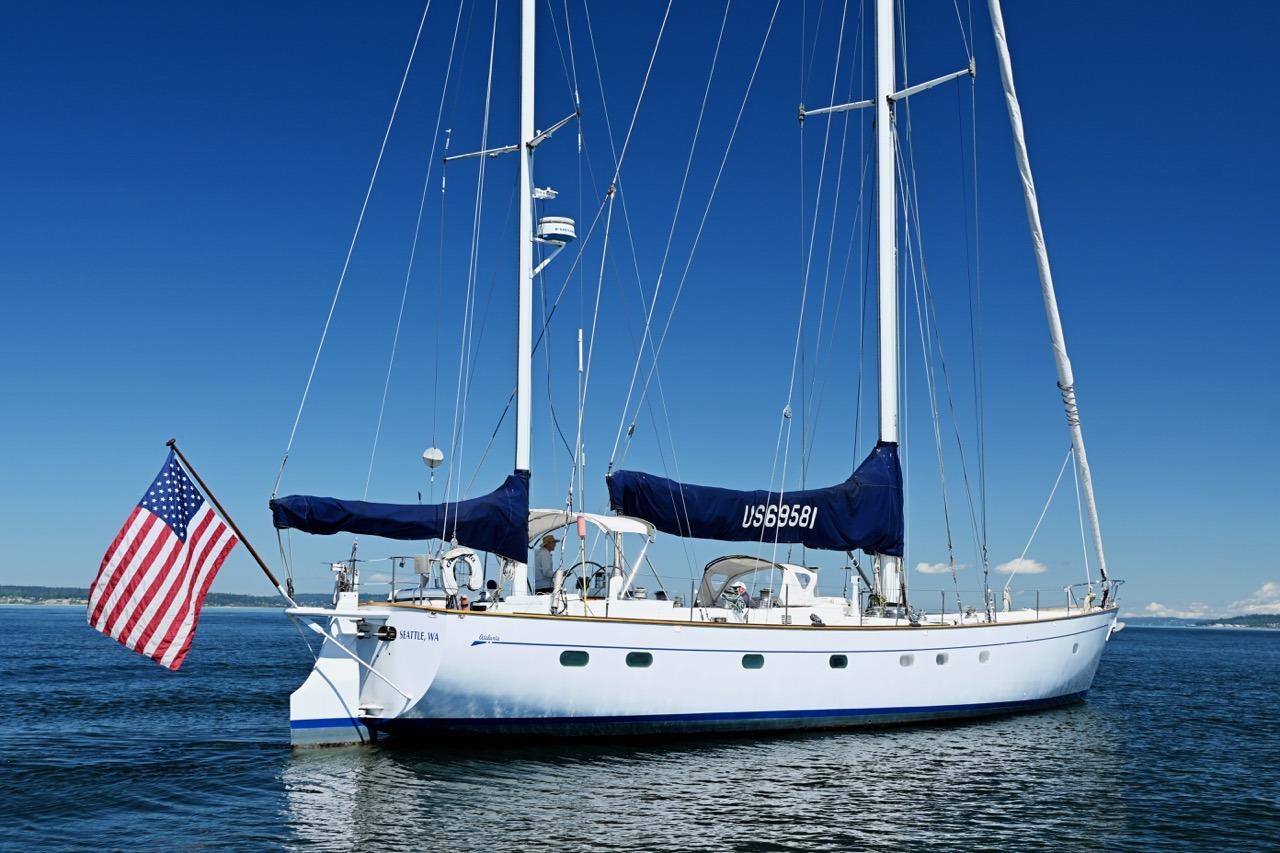 Sailing yacht Abeking & Rasmussen Tripp 74, 1968, with American flag on calm waters.