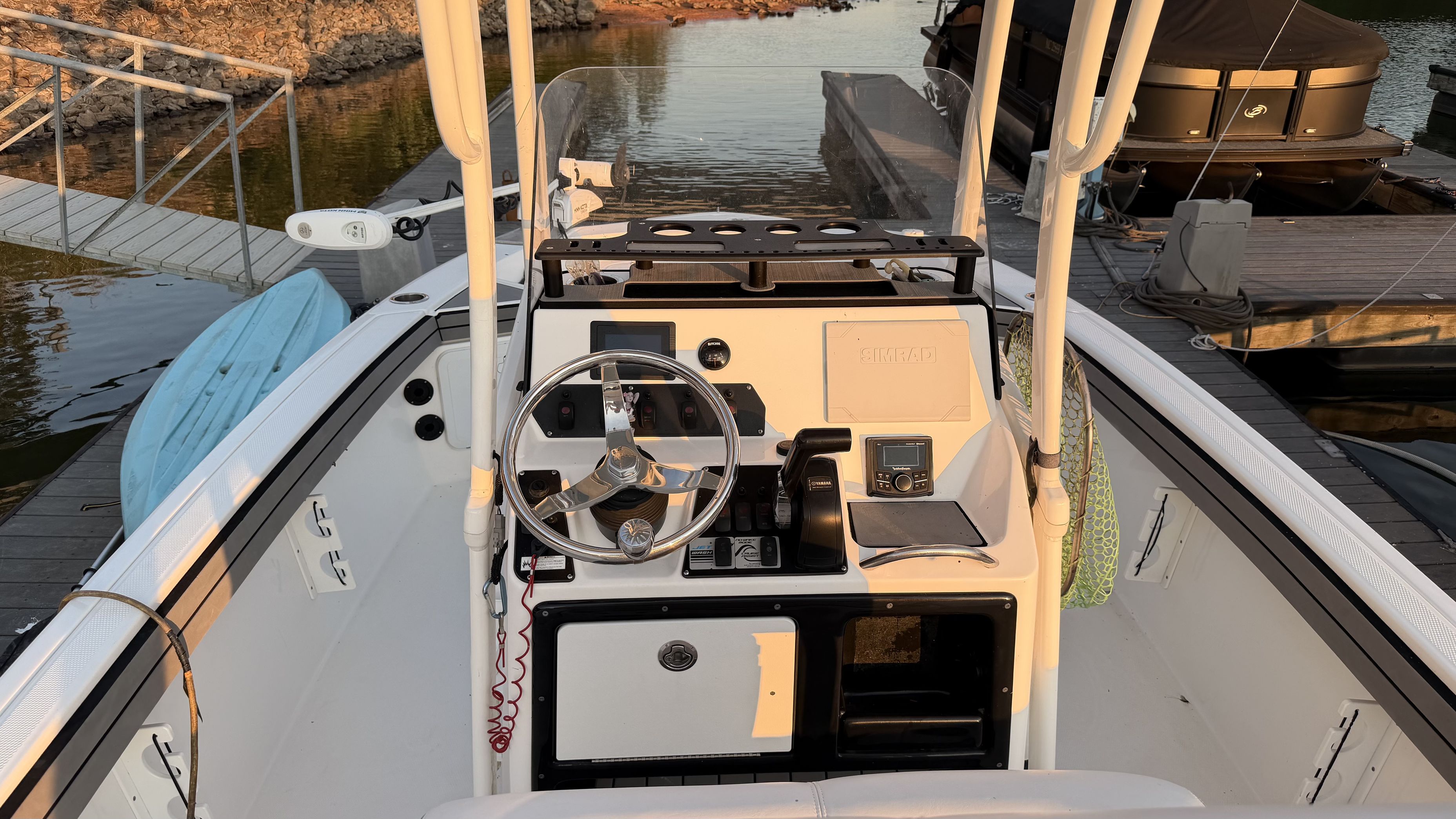 The image shows the cockpit of a 2019 Yamaha 190 FSH Sport boat at a dock.