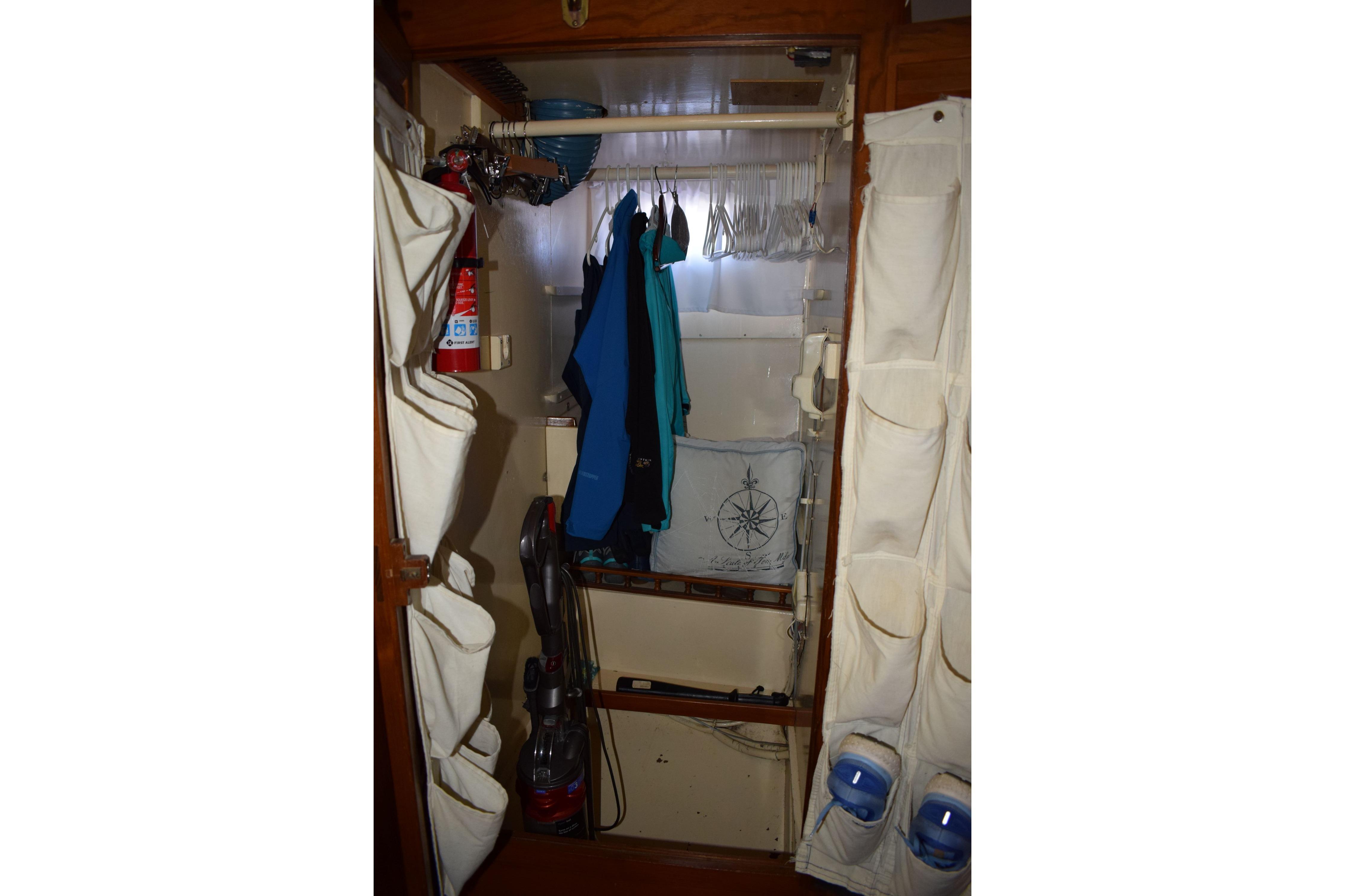 Interior closet of 1980 Cheoy Lee 52 Motorsailer with hanging clothes and storage.