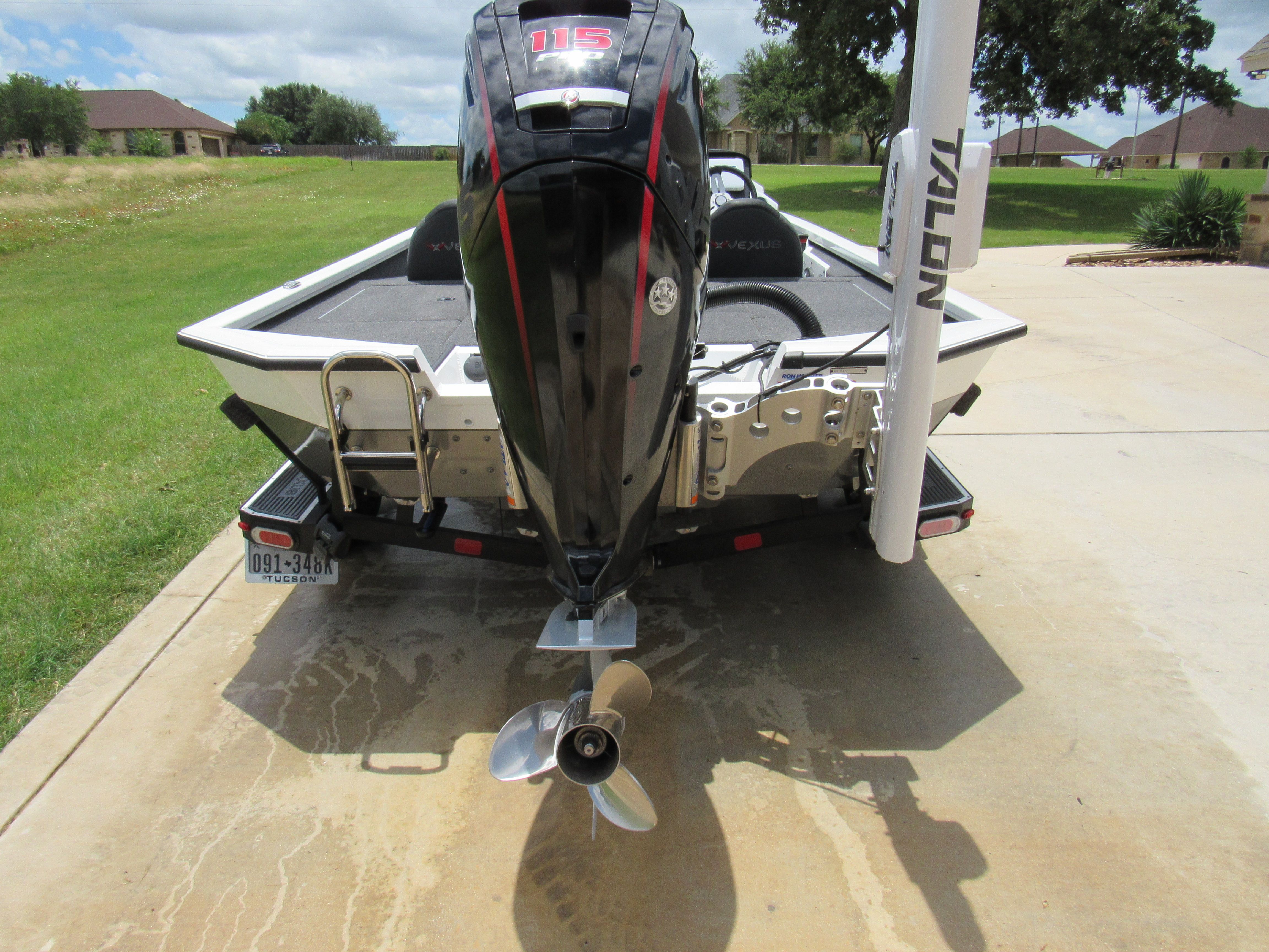 A 2019 Vexus AVX 1880 boat is parked on a driveway.