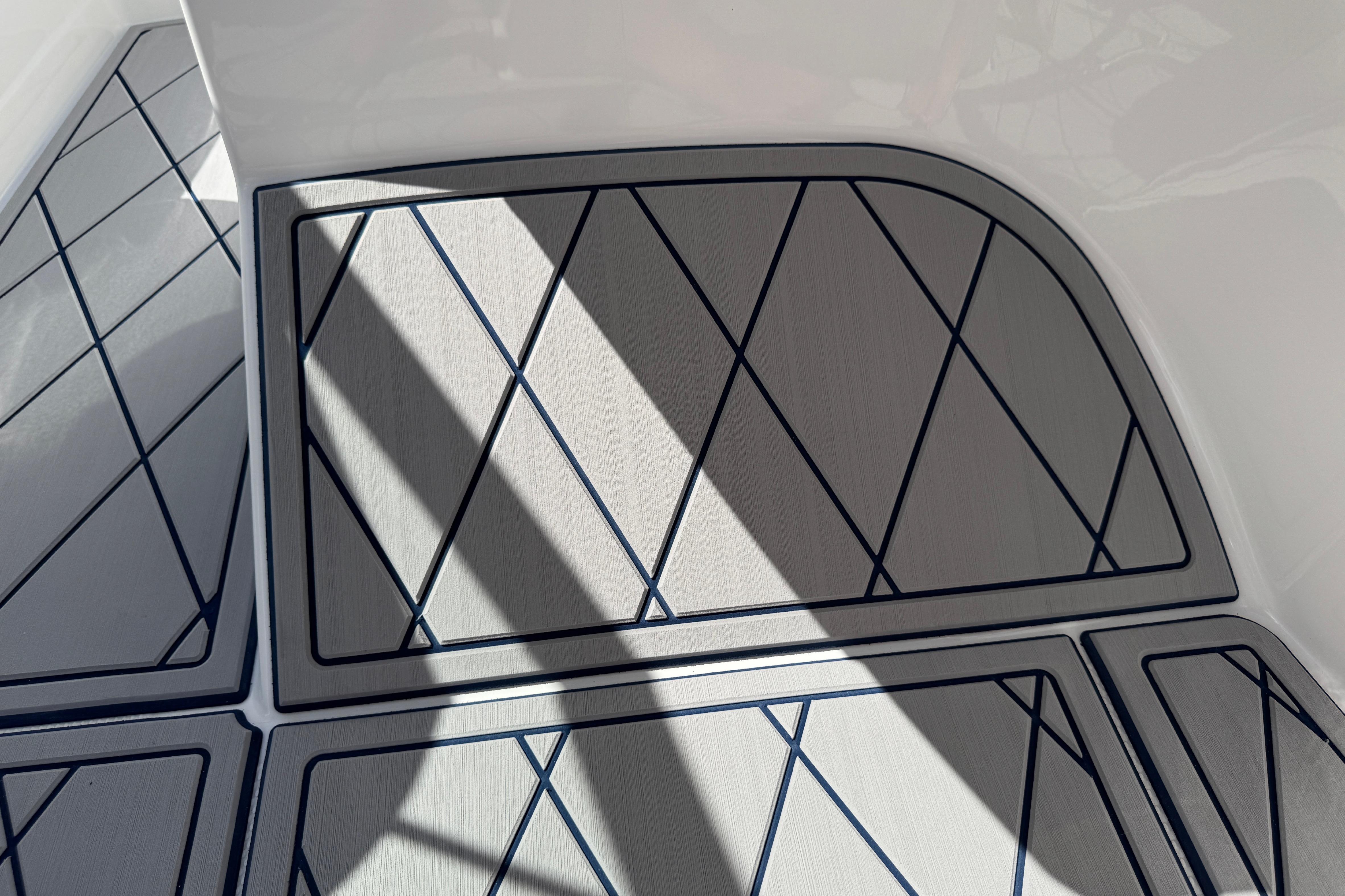 2024 Tahoe 185 S boat deck with geometric pattern and shadow play.
