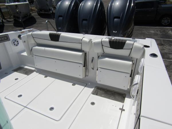 2024 Wellcraft 352 Fisherman boat with triple outboard engines and foldable rear seating.