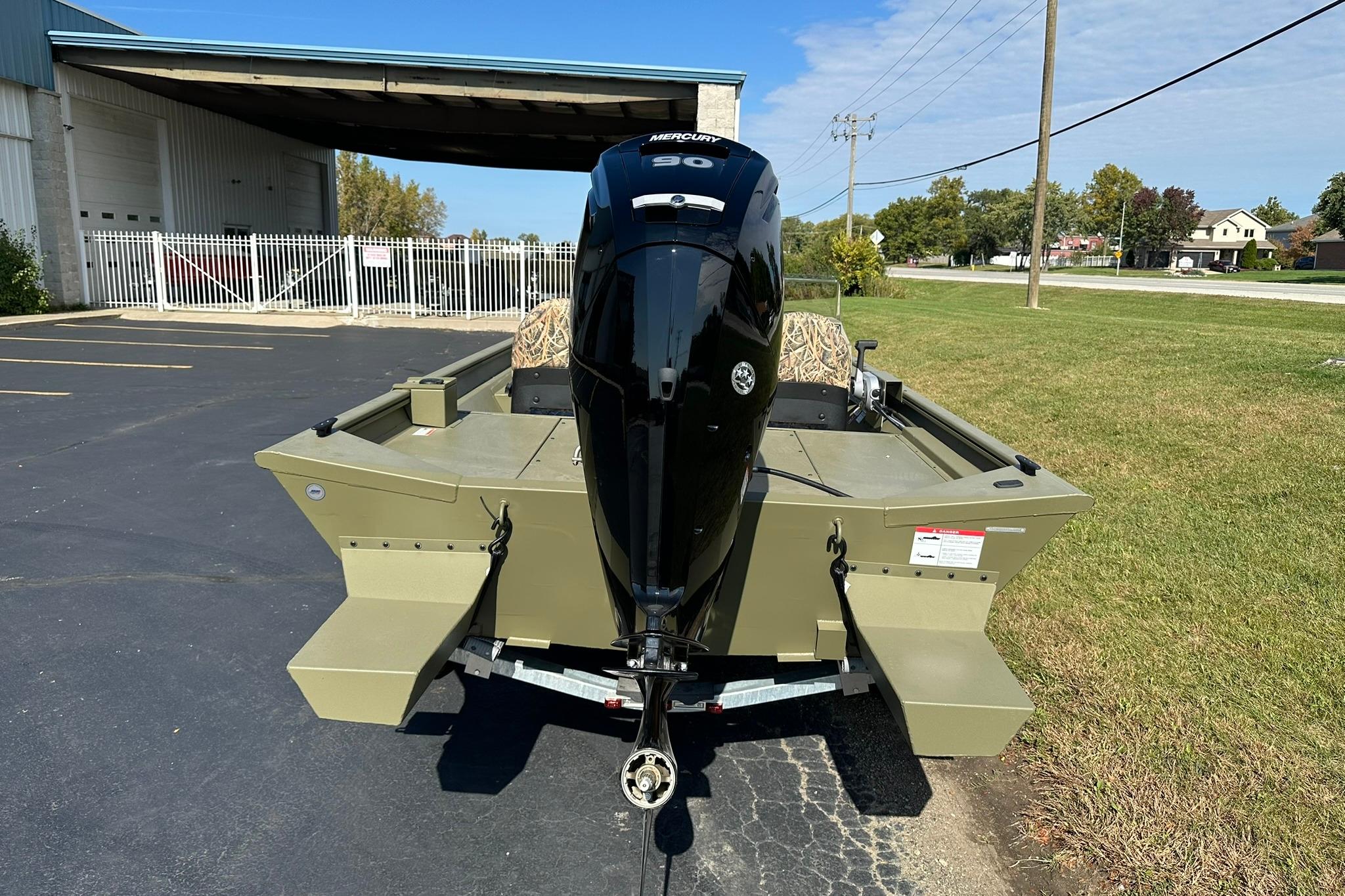 2026 Lowe Roughneck 1860SC boat with Mercury outboard motor, parked outdoors.